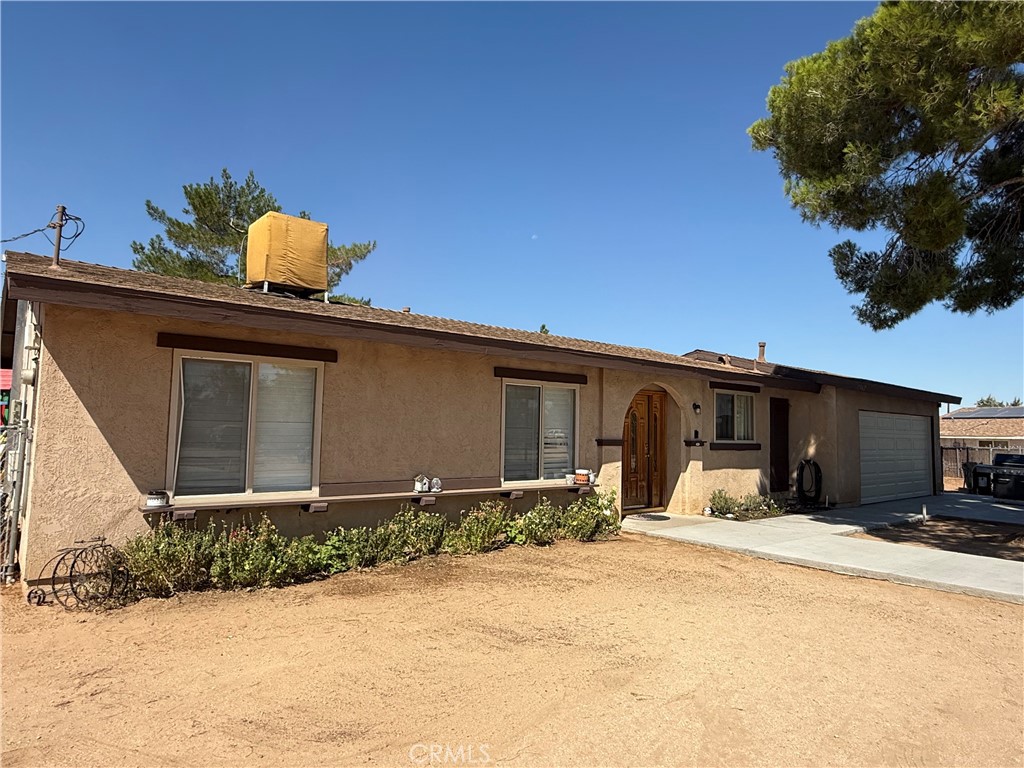 This ain't just a starter home, there is so much room for activities!! Did someone say BUILDABLE LOT??? This puppy is HUUUUUGE at over 3/4 acre!! And perfectly placed allowing for home expansion, additional dwelling, or maybe even a workshop! This adorably well kept single story home offers an easy floorplan with 3 bedrooms, 2 bathrooms, attached 2 car garage (newer door and opener), a large circular driveway (poured in the last 5 years), fully fenced rear yard with cross fencing for the dog yard and the garden area (with green house, raised beds and lighting), 2 large sheds (recently painted), and a BRAND NEW HVAC and Heating system with all NEW DUCTING (evap cooler is also available)! The interior offers updated kitchen and baths (within last 10 years), wood grain tile flooring throughout (within last 5 years), interior and exterior paint touch ups, FULL PLANTATION SHUTTERS, and French doors leading to the rear yard. With room for expansion, affordable pricing, and move in ready condition what are you waiting for! Home is HERE!