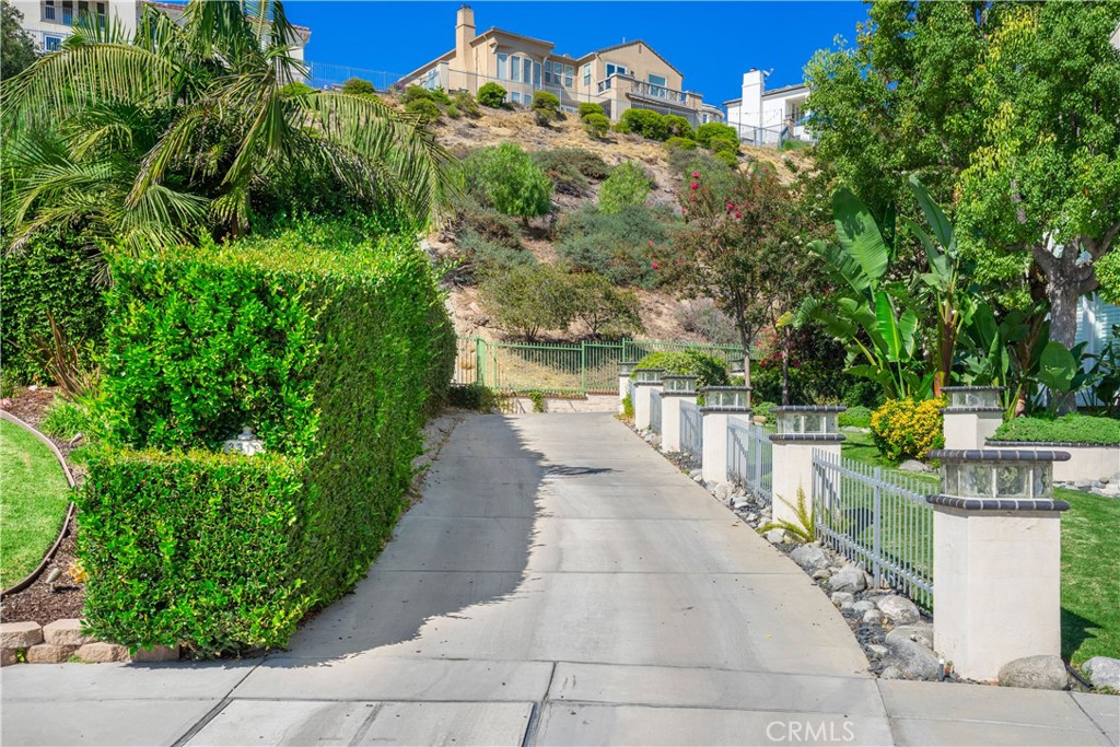 Experience life at the top in Hallston Estates, where this Burbank Hills retreat combines breathtaking views, complete privacy, and premier gated living.
A long private driveway with an electric gate leads you to this stunning 6-bedroom, 7-bathroom home perched high above the city.
This spacious floor plan includes two downstairs bedrooms, ideal for guests or a home office, and four additional bedrooms upstairs. The grand entry welcomes you with soaring ceilings and flows into formal living and dining rooms, both filled with natural light from floor-to-ceiling windows that frame the incredible views.
The gourmet kitchen features sleek quartzite countertops, rich custom cabinetry, and a large center island—seamlessly flowing into an expansive family room complete with a built-in bar, perfect for entertaining.
Enjoy breathtaking city lights and your own private fireworks show on the 4th of July from the comfort of your master suite balcony. The expansive primary retreat features a sitting area, spa-like bathroom with a jetted tub, and a show-stopping walk-in closet with built-ins.
Step outside to an entertainer’s paradise, featuring a sparkling pool, spa, and those dazzling city lights as your backdrop all year round.
As part of the coveted Burbank Hills gated community, residents also enjoy access to amenities including tennis courts, gated access and 24-hour security—all adding to the luxury and lifestyle this exceptional home offers.