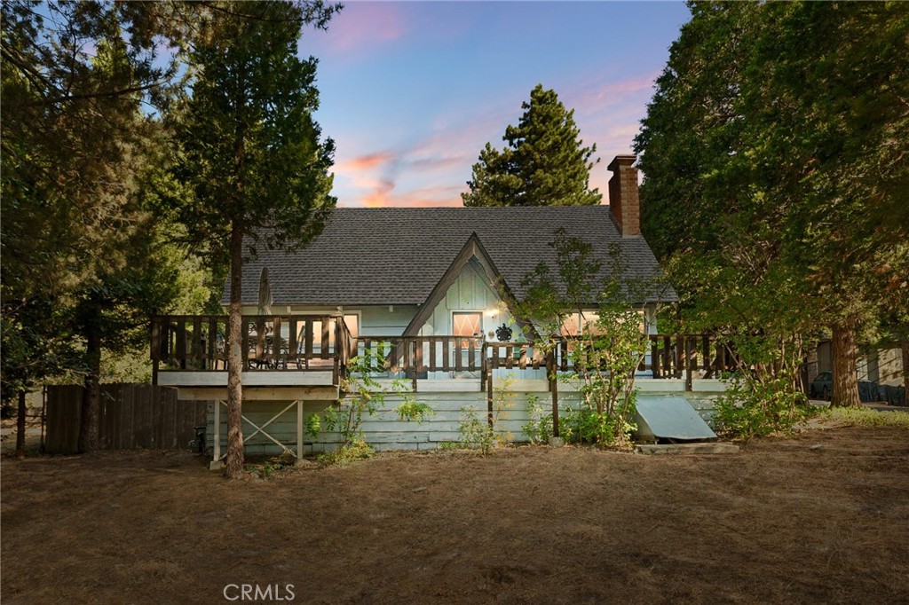Adorable cabin perched atop a spacious corner lot. Cute and clean, walk in to rustic vaulted ceilings and natural light in the living room. Main level has two bedrooms/bathroom and upstairs is a generous sized 3rd bedroom/loft area. Seller has updated kitchen with quartz countertop and backsplash, as well as dual paned windows, a tankless water heater and a water shut off valve. There is plenty of parking in front as well as a fenced yard, potential for FLAT RV parking, and a storage shed and washer/dryer inside. From the front porch take in the trees and peekaboo view of the valley below. Come spring time, lilacs and daffodils abound. Located in a great location for either your part time getaway or a full time move to the mountains.