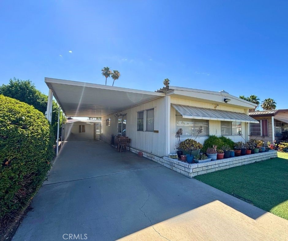 Welcome to 521 San Mateo Cir in the Sierra Dawn Estates, a vibrant 55+ community where you own the land—no land lease! This charming and well-maintained manufactured home features 2 spacious bedrooms and 1 upgraded bathroom, ideally located within walking distance to the pool, clubhouse, and community amenities. Step inside to find beautiful wood flooring throughout, a modernized kitchen with upgraded counters and backsplash, and newer blinds for a clean, updated look. The reglazed bath and standing shower offer a fresh, spa-like feel. Enjoy the convenience of in-unit laundry and a functional layout with a walk-in closet in one bedroom and sliding glass doors in the other, leading to a private, cemented backyard—perfect for relaxing or gardening. Additional highlights include a long carport, a newer storage shed, and access to an active, low-HOA community offering four clubhouses, billiards, games, community events, four pools, a dog park, and a gym. Don’t miss this opportunity to enjoy low-maintenance living in a wonderful neighborhood that feels like home!