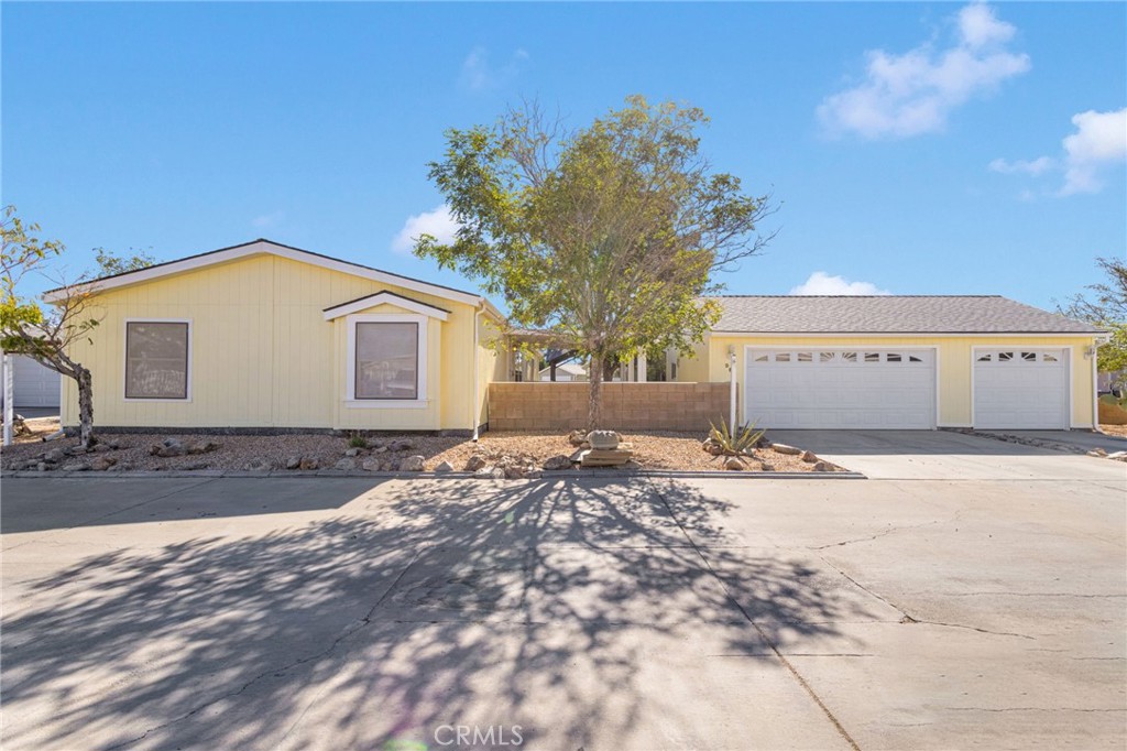 Charming, Spacious & Move-In Ready manufactured home in Vista Del Rosa! Welcome to this sunny and beautifully maintained manufactured home located in the desirable 55+ gated community of Vista Del Rosa. Offering 1,723 sq. ft. of living space, 4 bedrooms, 2 bathrooms, and a rare 3-car garage, this home is designed for both comfort and convenience. The spacious primary suite features double closets, room for a cozy sitting area or personal gym, and a private ensuite bathroom. With a split floor plan, everyone has their own space to enjoy. Inside, you’ll love the freshly painted interior, wood laminate floors, and plush carpet. The large kitchen is perfect for entertaining with its island, generous cabinet storage, pantry, and convenient access to the laundry room. The family room with vaulted ceilings flows seamlessly into the kitchen and formal dining area, creating an open, airy feel with plenty of natural light. Modern comforts include central heat/air, a brand-new mini-split in the kitchen, and a swamp cooler in the primary bedroom. Even better, the home boasts a new roof with warranty and freshly painted exterior for added peace of mind. Step outside to your extra-large premium lot, featuring a covered patio, pergola for outdoor dining, mature shade trees, and easy-care desert landscaping. The 3-car garage with workbench provides ample space for parking, hobbies, and storage. As part of Vista Del Rosa, you’ll enjoy resort-style amenities including a sparkling pool, tennis courts, clubhouse, and the security of a well-maintained gated community. This home has it all—space, upgrades, and community charm. Don’t miss your chance to make it yours!