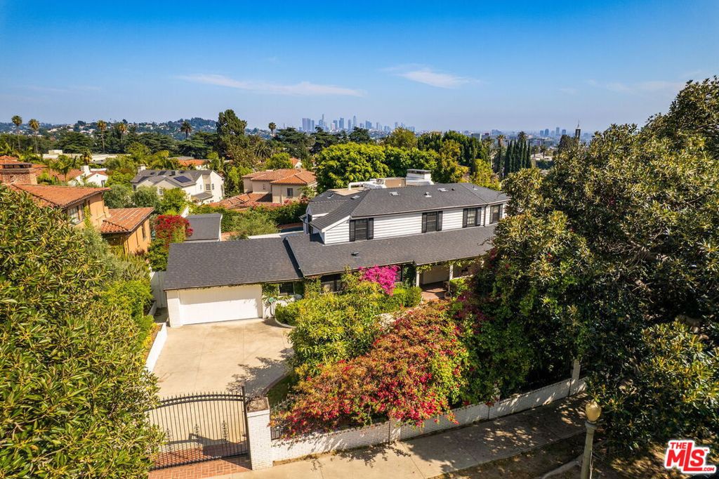 Welcome to this meticulously remodeled contemporary home, offering style, privacy, and prime location in the highly desirable Los Feliz neighborhood. Behind a large double gate and privacy wall, a long driveway leads to this stunning compound, creating an immediate sense of exclusivity.The main residence features an expansive living room, a formal dining room ideal for entertaining, a versatile library/family room, and a spectacular chef's kitchen equipped with top-of-the-line appliances and premium finishes. Oversized pocket doors and windows seamlessly blend indoor and outdoor living, opening to a breathtaking entertainer's backyard.Enjoy a luxurious Hamptons-inspired outdoor space with a sparkling pool, built-in BBQ, and wood-fired pizza ovenperfect for hosting unforgettable gatherings. A separate guest house with a private bathroom offers additional comfort and flexibility. Can be sold furnished. Located just minutes from the Hollywood Hills, Griffith Observatory, DTLA, and The Greek Theatre, this private retreat blends elegance, comfort, and convenience in one exceptional offering.Must see!