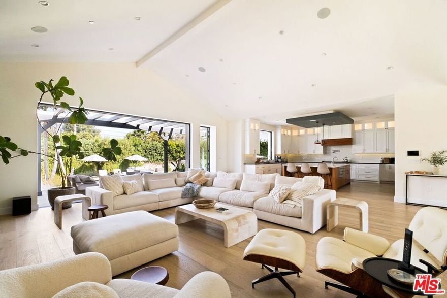 Presenting a stunning modern masterpiece in the heart of Woodland Hills, this newly constructed single-level residence, completed in 2020, embodies sophisticated luxury and timeless design. Perfectly positioned south of Ventura Boulevard on a picturesque, tree-lined street, this architectural showplace offers the ultimate in style, comfort, and California living.Behind private gates, this single-story residence showcases timeless curb appeal with smooth stucco, lush landscaping, and an expansive circular driveway leading to a covered entry. Inside, soaring vaulted ceilings, wide-plank European Oak floors, and custom built-ins create a seamless blend of warmth and sophistication.The gourmet chef's kitchen features sleek stone countertops, a large center island with breakfast bar, and top-of-the-line stainless steel appliances. The inviting great room flows effortlessly to the resort-style backyard, creating an ideal setting for entertaining and indoor-outdoor living.The serene primary suite was meticulously designed with designer Portola paint and a beautiful fireplace for a tranquil ambiance. It also offers direct access to the backyard, a spacious walk-in closet, and a luxurious spa-style bath with soaking tub, glass shower, and dual vanity. Two secondary bedrooms and a third private suite (all with ensuite bathrooms and walk in closets) perfectly situated for guests or a playroom complete the layout. A state-of-the-art movie theater with elevated seating and designer lighting provides the ultimate at-home entertainment experience.Step outside to your private oasis with a sparkling pool, elevated spa, outdoor BBQ kitchen, firepits, and a full pool bathroom with showerperfect for al fresco gatherings. Additional features include an attached two-car garage, owned solar panels with battery backup, and a Control4 smart home system controlling everything from lighting and security to music and window coverings all at the touch of a button or your phone. This exceptional gated property captures the essence of luxury and modern Los Angeles living with easy access to schools, trails, and the 101.