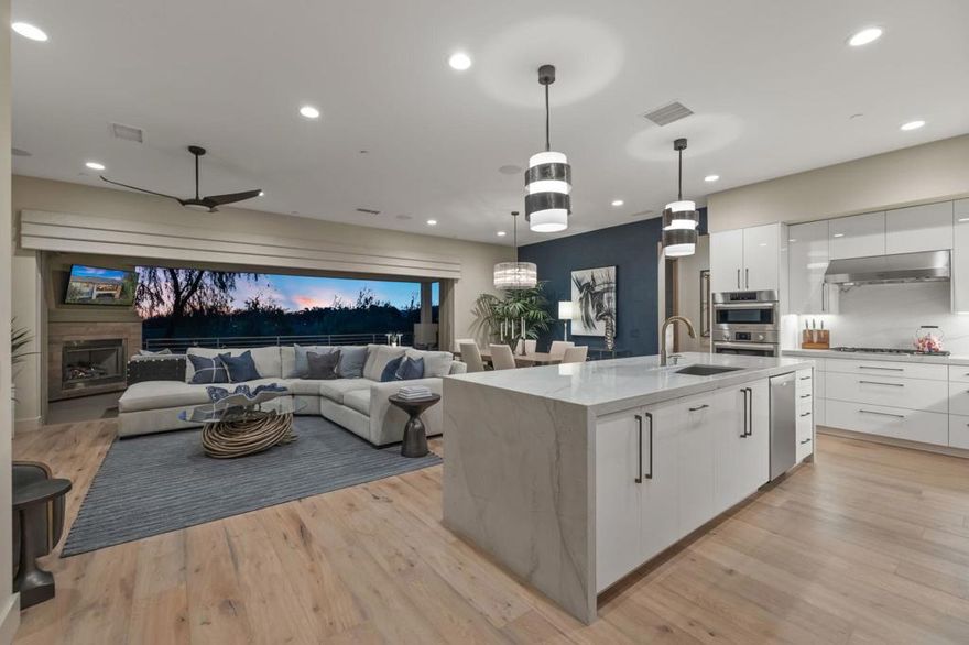 1 of 1 Custom Furnished Condo at The Retreat at Desert WillowA truly rare opportunity, this Plan 3 (The Preserve) residence is the only fully customized, designer-furnished home currently available at The Retreat at Desert Willow. Positioned on a premier lot with panoramic south mountain and east-facing golf course views, this exceptional property captures the essence of desert luxury living.Spanning just under 2,600 square feet, the home offers three bedrooms, two and a half bathrooms, and three private patios that invite seamless indoor-outdoor living. A private elevator connects the levels, while the two-car garage includes an AC mini-split, built-in storage, and an owned solar system with a Tesla backup battery.Every element of the interior has been thoughtfully curated, from the Control4 smart home automation system and upgraded variable-speed HVAC to the smooth coat drywall finish, solid-core interior doors, and five-inch baseboards. The open-concept design features wood flooring throughout, an elegant custom dry bar, and an outdoor fireplace that enhances the home's resort-like atmosphere. The gourmet kitchen is a centerpiece, showcasing Bosch and Sub-Zero stainless-steel appliances, quartz countertops with a waterfall edge, and meticulously crafted custom cabinetry. Designer lighting and plumbing fixtures--including Toto Neorest toilets--reflect a commitment to quality and sophistication, while electric roller shades and custom window coverings complete the refined aesthetic.Offered furnished per the seller's designer inventory, this one-of-a-kind property delivers the ultimate turnkey experience--combining innovation, style, and comfort in one flawless package.As part of The Retreat's exclusive 112-home enclave, owners enjoy membership to Desert Willow Golf Club as part of the association dues, along with direct golf cart access from the community to the course. Welcome home to The Retreat at Desert Willow, where sophistication meets serenity and every detail has been perfected for desert resort living at its finest.