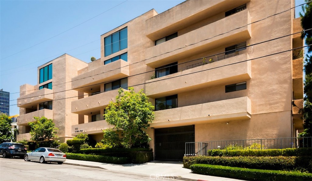 Welcome to Unit 201 at 930 N Wetherly Drive, a beautifully updated corner condo located on one of West Hollywood’s most desirable streets. This spacious 2-bedroom, 2-bath residence offers over 1400 square feet of refined living space in a quiet, boutique building just moments from Sunset Boulevard and Beverly Hills.
Inside, you’ll find an open-concept floor plan with rich hardwood floors, high ceilings, and abundant natural light. The living room features a gas fireplace and opens to a private wraparound balcony, ideal for morning coffee or evening relaxation. The chef’s kitchen includes quartz countertops, custom cabinetry, and stainless steel appliances, flowing seamlessly into a generous dining area. The oversized primary suite offers a walk-in closet and a stylish ensuite bathroom with dual vanities and a walk-in shower. The second bedroom provides flexibility for guests, a home office, or a creative space. Additional highlights include in-unit laundry, central HVAC, recessed lighting, extra storage, and two gated side-by-side parking spaces. The well-maintained building has secure entry, a recently updated lobby, and low HOA dues.
This is a rare opportunity to own a turnkey home in the heart of West Hollywood, close to world-class dining, shopping, and nightlife.