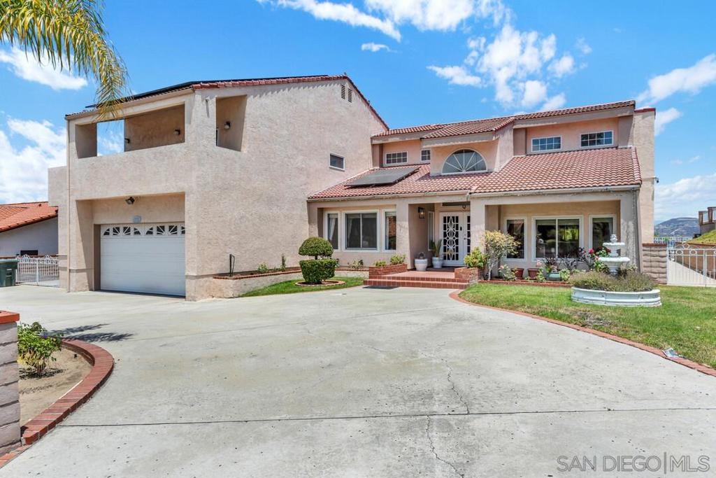 Stunning home with solar and panoramic mountain views! Nestled in a peaceful location just east of the 125 freeway, this beautiful home offers both energy efficiency and breathtaking scenery. Step inside to soaring ceilings and an abundance of natural light that fills the spacious layout. The primary suite is conveniently located on the first floor, featuring a luxurious en-suite with a soaking tub, stand-up shower, and a massive walk-in closet. A wall of windows and sliding glass doors in the primary bedroom open to sweeping mountain views and serene natural surroundings. The main level also offers multiple living spaces including a formal dining room, a separate living and family room, and a large laundry room that doubles as a prep space or chef’s kitchen. The heart of the home is an open-concept kitchen, perfect for both everyday living and entertaining. Upstairs you'll find three generously sized bedrooms, each with access to balconies that offer incredible views. Two bedrooms share a connecting balcony, while one features an en-suite full bathroom, making it ideal as a secondary primary suite or private guest room. All bedrooms include ample closet space. The backyard is an entertainer’s dream, featuring a built-in BBQ, expansive patio space, a built-in storage shed under the patio, and an additional tiered yard area below. Located on a tranquil street with minimal through traffic, this home also offers easy access to the 125, 52, 67, and 8 freeways, and is just minutes from local schools, Grossmont Center, Mission Trails and so much more. This is a must see!