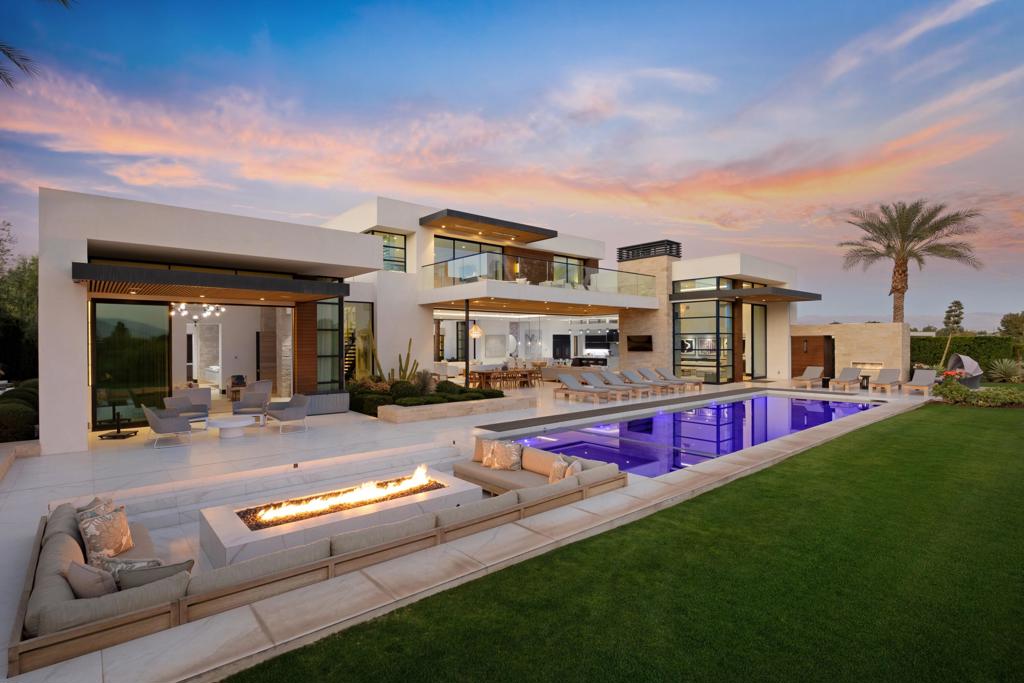 Welcome to The Madison Club! This stunning 8,085 sq ft contemporary home boasts 5 bedrooms 5.5 baths, media room, soaring ceilings and two-story wine wall. Automated doors slide away to create an expansive entertaining area that stretches from the interior courtyard to backyard pool. Outdoor patio areas are complete with lounges and fire features throughout. Stunning panoramic views of the Santa Rosa mountains and the 4th green of the acclaimed Tom Fazio course await you in this south facing masterpiece. This home is an entertainer's dream!