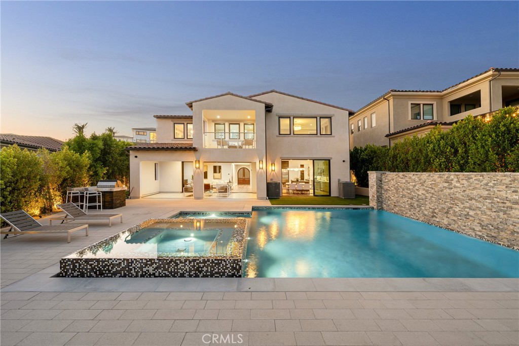 Luxe highly updated Toll Brothers home with jet-liner views of the San Fernando valley. This home greets guests directly into a two-story foyer with designer lighting and European Oak Floors. An extra wide sweeping staircase sits adjacent to a glass enclosed office with sliding doors to a grass covered side yard. The open floor plan free flows into an elegant family room complete with custom built-ins, surround sound, and pocket sliding doors that open to the private entertainer's backyard. A Gourmet Chef’s kitchen boasts stone countertops, dual islands with one with prep sink and a second serving as a breakfast bar, walk-in pantry, and stainless-steel appliances. Upstairs the lavish Primary suite includes a private balcony with breathtaking views, fireplace and two luxurious custom walk-in closets. The spa-like master bathroom has dual vanity, water closet, soaking tub, and massive standing glass rain shower. Three additional upstairs bedrooms perfect for family or guests. Entertain year-round with a sparkling pool & spa with LED lighting and large waterfall, covered patio perfect for al fresco dinners and a barbecue center with large marble top. Additional luxuries include Control-4 smart home system, linear air vents, automatic security shades, 2-car finished garage, indoor/outdoor surround sound, and security cameras throughout. Experience what porter ranch has to offer, A luxurious lifestyle close to fine dining shops and more.