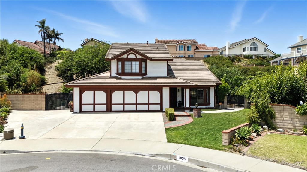 Your Dream Home Awaits in South Diamond Bar! Nestled in a peaceful cul-de-sac in the hills of South Diamond Bar, this stunning 4-bedroom, 3-bathroom home offers the perfect blend of elegance, comfort, and functionality—all within the boundaries of the award-winning Walnut Valley Unified School District. Step inside to soaring vaulted ceilings & light-filled living room that flows into the formal dining area. The heart of the home is the newly remodeled kitchen, featuring quartz countertops, stainless steel appliances, and ample cabinetry. Just off the kitchen is a den updated with custom built-ins, floating shelves, and recessed LED lighting—perfect for movie nights. The 1st floor bathroom has also been renovated with modern finishes. Upstairs, is the spacious primary suite with vaulted ceilings, two walk-in closets, his-and-hers sinks, and an oversized soaking tub. Three additional bedrooms offer flexibility for children, guests, or a home office, with a second full bathroom nearby. Zebra shade window treatments throughout the home give it a sleek edge, while the new carpet and fresh paint make this home truly move-in ready. Sitting on nearly half an acre, the backyard is an entertainer’s paradise and a nature lover’s dream. Enjoy a massive covered patio with dual ceiling fans and string lights for twilight dinners. One side of the property boasts your very own fruit orchard, featuring 12+ mature trees: White and red pomegranates, Honeycrisp apple, Jujube (Chinese dates), Loquat, Guava, Avocados, Asian pear, Pomelo, Sumo citrus, and more! The opposite yard features a large grassy area bordered by drought-tolerant landscaping, perfect for kids to play, morning yoga & workouts. The backyard is bordered by serene hillside greenery, giving you the feel of being immersed in nature—while still minutes from city conveniences. The large lot offers incredible potential for an ADU or pool. The 3-car garage has built-in 240V EV charging outlet. The driveway fits 4–5 vehicles plus, side gate access for RV parking. New HVAC system and ducting. Smart home features include Nest thermostat, smart sprinklers, and Chamberlain garage opener, all controllable via smartphone. Termite home protection good through 2031. Minutes to major freeways, shopping, dining, parks, and hiking trails—yet tucked away in one of Diamond Bar’s most serene neighborhoods. Don’t miss your opportunity to own this one-of-a-kind home in one of SoCal’s most coveted school districts!