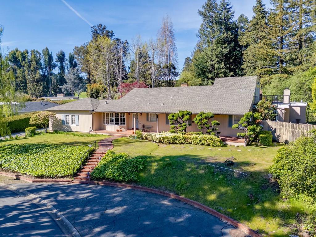 Nestled in Hillsborough's prestigious Ryan Tract, this exceptional residence blends privacy, convenience, & charm. Just minutes from Downtown Burlingame & Broadway, it offers easy access to Highway 101 and top-rated schools. A welcoming front porch leads into a bright & airy interior w/ hardwood floors, recessed LED lighting, and expansive windows. The elegant dining room features a bow window & connects to the updated eat-in kitchen w/ granite countertops, a glass tile backsplash, high-end appliances, & a breakfast nook. The living room centers around a striking fireplace flanked by French doors & a picture window. A refined study offers built-in shelving, a fireplace, a wet bar, & backyard access. The primary suite includes custom built-ins, fireplace, French doors to a private deck, & a spa-like bath with a jetted tub, a walk-in shower w/ a functioning steam bath unit, & a walk-in closet. Upstairs, a versatile art studio opens to a private balcony. 2 additional en-suite bedrooms & a powder room complete the home. The beautifully landscaped backyard features a large patio w/ a fireplace, a lush garden, & an expansive lawn. A paver motor court & discreet garage enhance curb appeal. 680 Fairway Circle is a rare opportunity in one of Hillsborough's most sought-after neighborhoods.