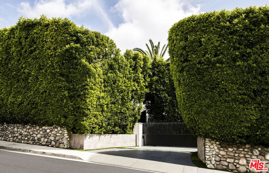 Take a one-minute trip from the iconic Beverly Hills Hotel and arrive at this private modern estate tucked behind gates and mature landscaping in the best location in Beverly Hills. Offering 12,664 SF of air-conditioned space and a total of 16,646 SF under roof on an expansive 28,747 SF lot, this extremely well-built, stylish, and masterfully designed compound features a flawless floor plan with 9 bedrooms and 13 bathrooms. Being sold by its only owner since completion, the estate offers the highest level of accommodation for the high-end future owner. Designed with high ceilings on all levels and beautiful walls for the sophisticated art collector, the feel of home and the sense of an exciting vacation blur the line.  The main floor boasts a sizable kitchen with a giant island that includes seating, opening to a family room with a beautiful staircase. Just around the corner, a living room with a bar, an oversized elevator, a cozy spacious den and an office with a private meeting room that all spill out to the spectacular hotel-like covered patio and grounds, complete with a sparkling swimmer's pool, spa, waterfall, fire pit lounge, barbecue kitchen under a steel pergola and a basketball area. The second floor features a luxurious primary suite with dual baths and walk-in closets and an oversized covered deck overlooking the pool along with three additional second-floor suites. There are also two suites on the main floor (one with a private entrance) and three detached casitas (two connecting with a receding sliding door) to complete the total of nine bedroom suites on the compound. Super inviting and high ceiling basement level with an expansive and fabulously appointed theater with receding blackout wall opening to a large game room, bar and temperature-controlled wine room.  Subterranean garage for 8-plus cars with easy access for sports cars along with a dual-gated drive-thru motor court wrapping the property in endless parking onsite, perfect for entertaining flow.  Indooroutdoor California living at its finest with complete serenity yet immediate access to the world's finest shops, restaurants, hotels, and spas.