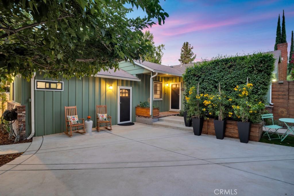 Step into this beautifully updated Ranch-style home, ideally situated South of the Boulevard, where classic charm meets modern sophisticated and luxurious family living. As you enter through the front door, you’re greeted by a tastefully designed and elegant chef’s kitchen with Café appliances and an island that seats five, perfect for gatherings and entertaining. This bright, open space flows effortlessly into the inviting living room, complete with a cozy fireplace—an ideal layout for comfortably spending time with family and friends. The front yard is fully gated, offering exclusivity and privacy, enhancing the home's wonderful curb appeal. You will enjoy the yard as your own private oasis with a sparkling solar-heated pool, surrounded by a serene patio that's perfect for relaxing or hosting summer get-togethers. A standout bonus and ultra convenient 374 square foot permitted ADU, featuring a modern kitchen, stainless steel appliances, an expensively remodeled bathroom, laundry with brand new LG washer and dryer, and an 86-inch screening room with in-ceiling Sonos surround sound. The versatile guest house area can serve as a home office, gym, fully functioning guest suite. bonus room, and or generate substantial rental income. Inside the main house, you’ll find 3 spacious bedrooms and 2 beautifully remodeled bathrooms. The oversized primary suite with its own fireplace, spacious sitting area, walk in closet, and stunning ensuite bathroom. French doors open directly to the peaceful patio making the transition from indoor to outdoor seamless. The home features brand new engineered hardwood flooring throughout, high end upgrades and improvements throughout, and two additional sets of brand-new LG washers and dryers for your convenience. Additional highlights include a Level 2 EV charging port, CCTV security system, and solar heating for the pool. Located just minutes from The Village at Topanga, 101 freeway, famous restaurants, The Warner Center, Trader Joe’s, Whole Foods, local hiking trails, and a quick drive to Malibu beaches, this property offers the perfect blend of style, comfort, and convenience. This property truly has it all!