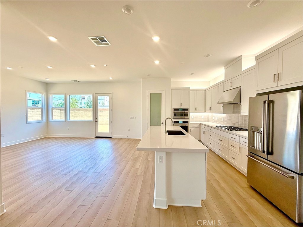 Welcome to this stunning, BRAND-NEW two-story home located in Irvine’s highly sought-after Great Park neighborhood. Built in 2025, this 4-bedroom, 4-bathroom residence offers modern luxury, thoughtful design, and high-end upgrades throughout. The open-concept main level features a spacious living area with soaring ceilings, recessed lighting, luxury vinyl plank flooring, and a private bedroom with a full bath—ideal for guests, multigenerational living, or a home office. Upstairs, a versatile loft is surrounded by three additional bedrooms, including a luxurious primary suite with a spa-inspired bathroom and an expansive walk-in closet. With no front neighbors and an abundance of natural light, the home feels bright, open, and welcoming. Enjoy one of the LARGEST and most PRIVATE BACKYARDS in the community—professionally landscaped to create a perfect space for entertaining or relaxing. Energy-efficient features include solar panels, a Tesla Powerwall, a Tesla EV charger, central HVAC, and a Ring security system. As a resident, you’ll have access to world-class community amenities including resort-style pools, spas, parks, playgrounds, BBQ areas, and basketball and pickleball courts. This exceptional lease opportunity blends luxury, efficiency, and lifestyle in one of Irvine’s premier communities.