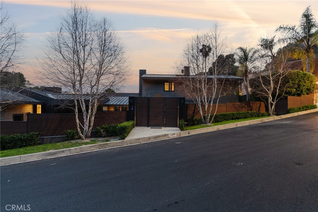 This designer home is located in the prime Bird Streets masterfully and fully remodeled in 2019 by noted designer Michael Palumbo. Designed to the very last detail, an exquisite blend of luxury, privacy, and cutting-edge technology. From the gated secure entry through the private landscaped grounds, this property offers a lavish indoor outdoor entertainment flow, vaulted cedar ceilings, oak floors, dramatic marble fireplaces, Control 4 home automation system as a part of the advanced technology of this home and much more. The lush private grounds include a pool and spa, surrounded by mature hedges and trees for seclusion. An enchanting stone waterfall, multiple fire pit seating areas, built in bbq area, and a covered al fresco dining space create an entertainer’s paradise. The sleek chef’s kitchen is equipped with Miele appliances, Italian cabinets and a skylight that bathes the space in natural light. Two ensuite bedrooms are located downstairs—one featuring a fireplace, and the other offering picturesque views with the direct access to the pool. The private primary suite upstairs is a sanctuary of luxury, boasting a vaulted cedar ceiling, a marble fireplace, a spa-like bathroom and a custom closet with an open design. Large glass doors open to a private rooftop deck with a fire pit and panoramic city light views. The state of the art finishes and unparalleled indoor-outdoor flow make this residence feel like a luxurious chalet sanctuary—just minutes from the best of Sunset Boulevard and Beverly Hills. A special gem that truly defines modern luxury living.