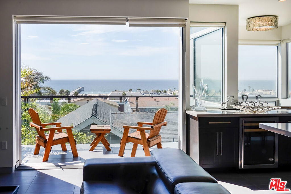 Welcome to 1204 Monterey Blvdwhere coastal charm meets modern elegance in the heart of Hermosa Beach. This rare offering features two homes on one lot, presenting a unique opportunity to live in one and rent the other for additional income or multigenerational living.The main residence is a beautifully designed coastal retreat with an open floor plan that seamlessly connects indoor and outdoor spaces. Large sliding glass doors flood the living area with natural light and frame panoramic views of the Pacific Ocean. The expansive layout is ideal for entertaining, complete with a chef's kitchen featuring top-of-the-line stainless steel appliances, custom cabinetry, and a large center island with breakfast bar. The luxurious primary suite includes a spa-inspired en-suite bath, walk-in closet, and tranquil ocean views. Three additional bedrooms provide flexibility for family, guests, or a home office.The bonus front house is filled with natural light and coastal characterwhite walls, wood-beamed ceilings, and white wood floors create a bright, welcoming atmosphere. Whether used as a rental for passive income, a guesthouse, or space for extended family, it offers incredible versatility without compromising privacy.Located just a short stroll from the beach, shops, and acclaimed restaurants, this property is a true Hermosa Beach gem. It's perfect for families looking to invest in a lifestyle and generate income at the same time.
