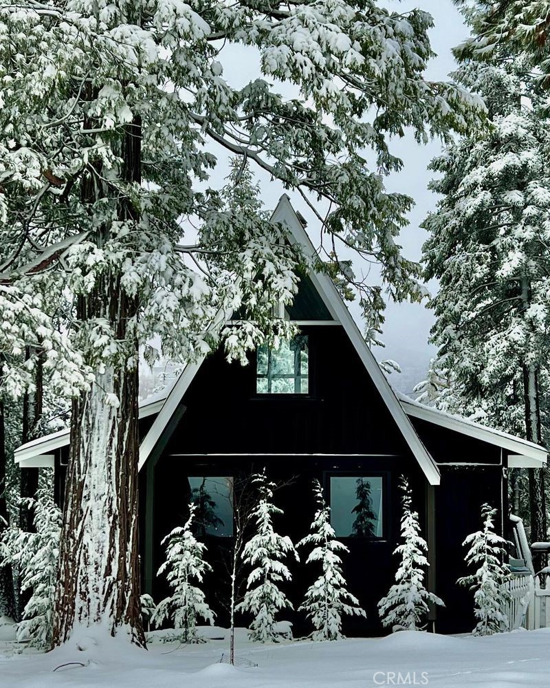 Welcome to your charming mid-century A-frame retreat at 767 Grass Valley Road, nestled in the serene community of Lake Arrowhead. This delightful two-bedroom, one-bathroom home plus a spacious loft spans 1,032 square feet and boasts much-coveted lake rights, allowing you exclusive access to the breathtaking Lake Arrowhead.
Step inside to discover an updated kitchen outfitted with premium GE Café appliances, perfect for the culinary enthusiast. The updated bathroom adds a touch of modern convenience, while the cozy living room features a fireplace, ideal for those chilly mountain evenings.
Dual access enhances the convenience of this property, and the roof, just six years old, ensures peace of mind. Situated on a generous 12,450 square foot lot, the home offers picturesque views of the surrounding trees and woods, providing a tranquil backdrop to your everyday life.
Positioned near Grass Valley Park and just moments from Blue Jay and Lake Arrowhead shopping areas, as well as local schools, this home combines the best of both worlds—seclusion and accessibility.
On the lowest level you will find an over 200 sq' bonus room (not included in square footage) with separate access ready for you to add personal touches and create an additional bedroom or flex space.
Don't miss the opportunity to own this quintessential Lake Arrowhead property, steeped in mid-century charm and modern comforts.