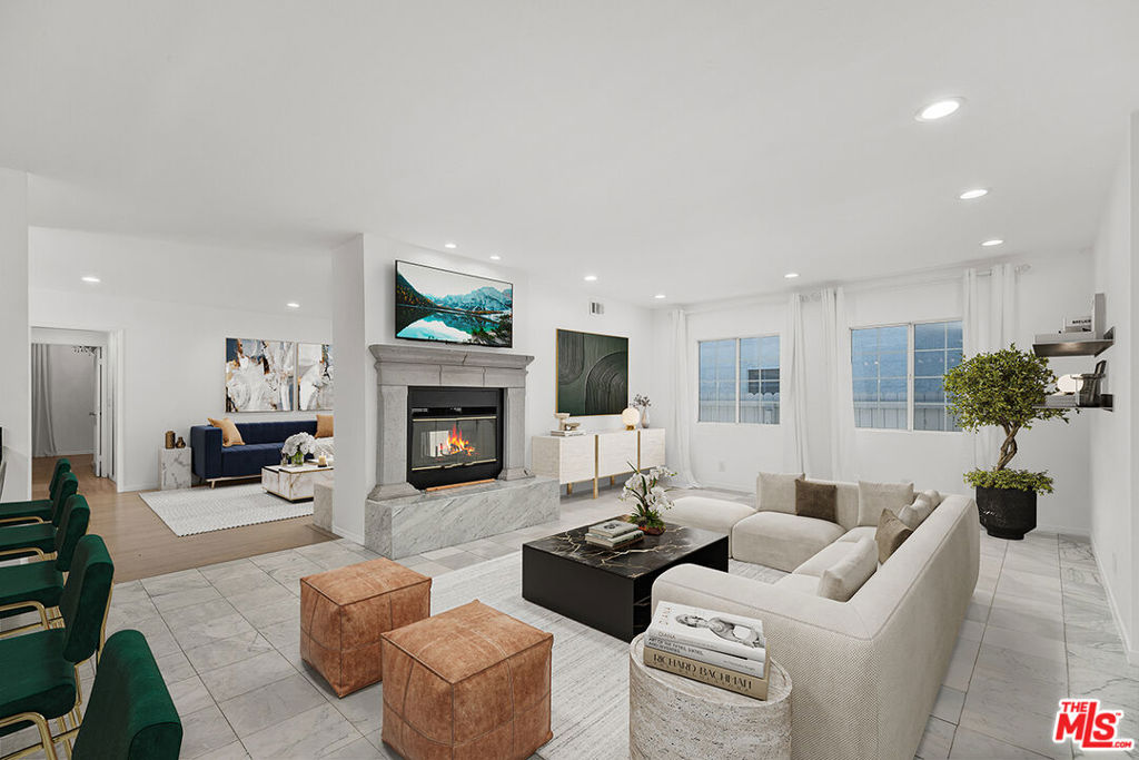 Nestled on a picturesque, tree-lined street in the heart of Studio City, this beautifully refreshed and light-filled 3-bedroom, 2-bath traditional residence blends charm, sophistication, and functionality. Offering over 2,050 sq ft of well-appointed living space, the home features a desirable open layout perfect for both everyday comfort and stylish entertaining.The elegant living and family rooms are centered around a striking double-sided stone fireplace, creating a warm and welcoming ambiance. The chef-inspired kitchen is outfitted with granite countertops, sleek cabinetry, stainless steel appliances, and a breakfast bar that comfortably seats five, ideal for casual mornings or evening gatherings. The spacious primary suite is a private retreat complete with its own sitting area, fireplace, chandelier, and French doors leading to a covered outdoor terrace shaded by a modern awning perfect for morning coffee or alfresco dining. The versatile third bedroom with en-suite bath is perfectly situated to serve as a guest suite, den, or dedicated home office.Other highlights include marble and hardwood flooring throughout, in-unit washer/dryer, central HVAC, and an attached 2-car garage. Located minutes from Ventura Boulevard's best dining, shopping, and cafes, and within close proximity to studios, top-rated schools, and Laurel Canyon for easy Westside access. Available for immediate occupancy. Offered unfurnished. Minimum one-year lease. Disclaimer: Some photos have been virtually staged for illustrative purposes. Actual furniture and decor may differ.
