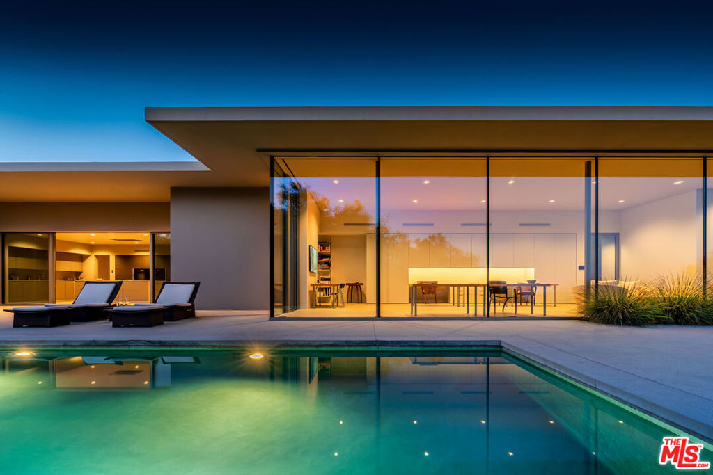 Situated along a ridge line between the mountains and the sea in Montecito, California-based Warner Group Architects' CEO and Principal, Thiep Cung, created a modern and minimalist retreat for his clients renown for their indoor/outdoor furniture and textile designs, resulting in a one-of-a-kind resort-at-home residence made for living amidst the legendary beauty of the American Riviera in coastal Santa Barbara. Reimagined through remodeling and expansion completed in 2021, the property is defined by sensory architecture where you will immediately be transported to a place of modern sanctuary as restorative to experience as it is beautiful to see with vistas of the ocean and coastline, while turning majestic mountain views into ever-changing artwork. Immerse yourself in the airy expanseand volume of 12- and 9-foot ceilings across the home where the great room, kitchen and artist's studio are framed by soaring architectural glass walls eliminating the boundaries between indoor and outdoor living. Natural light dramatically enlivens the home throughout the day accentuating both strong and subtle design details while inspiring and embracing slow living.This unique 4-bedroom, 4.5-bathroom residence of approximately 4,578 sq. ft. embodies understated elegant living with its sophisticated yet neutral color palette echoed in nature. Limestone flooring in the great room sets the stage for gatherings and entertaining. Spaciously designed gourmet kitchen opening to the pool terrace features Bulthaup b3 custom cabinetry and Miele appliances in luxurious finishes and colors elevating culinary creations to an art form. Large studio/office/bonus room with lots of storage is one of the home's best areas in which to design your days overlooking the great outdoors. Experience the luxury of quietly automated shade in the primary suite, providing seamless control over natural light and privacy, alongside an opulent bathroom adorned with porcelain surround tile work, countertop-to-ceiling mirrors creating a luxurious spa-inspired master suite with lavish amenities and complemented by two expansive walk-in closets and plentiful storage space. Every room benefits from a whole-home water filtration system and solar heating.For the tech savvy, two charging stations in the garage cater to electric vehicles, enhancing the convenience and eco-consciousness of modern living. A seamless Savant system ensures intuitive control across the built environment through lighting, temperature, music, entertainment, skylights, automated shades, and security cameras to optimize a highly personalized living experience. Outside, amidst heritage olive trees, the poolside ambiance invites relaxation and outdoor entertaining, set against a backdrop of majestic trees, blue seas and the mountains. This residence embodies the essence of unparalleled coastal living, where every detail from the luxurious finishes to the serene privacy converges to create a haven of tranquility and refinement.**** Photos courtesy of Kelly Teich of Warner Group Architects and Eric Foote Photography ****