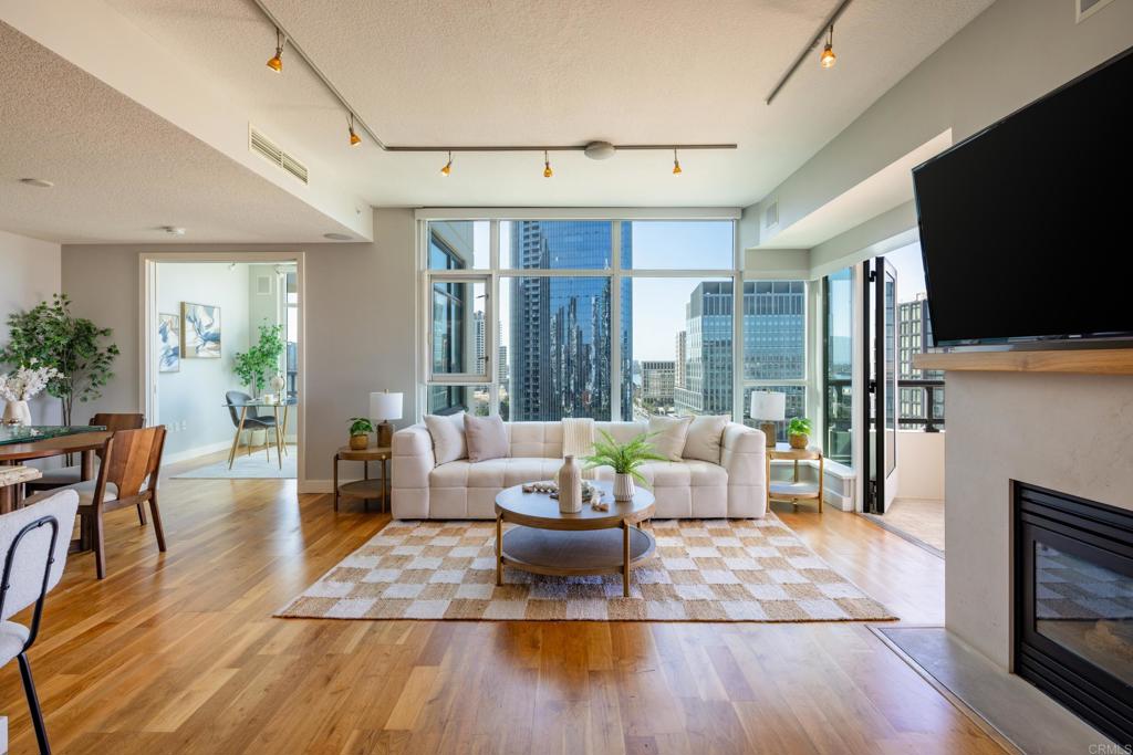Panoramic bay & skyline views are the centerpiece of this luxury condo at the iconic Grande South on Millionaire’s Row. The open-concept design showcases expansive windows in every room that fill the space with natural light and frame sweeping views of the harbor and downtown. The custom kitchen is appointed with granite countertops, stainless appliances, wine fridge, and counter seating that flows seamlessly into the living and dining area. Step outside onto your private balcony, perfectly positioned to take in sunsets over the water. The primary bedroom with ensuite bath has a dual vanity, soaking tub, and walk-in shower. An optional third bedroom offers the flexibility to create an incredible home office or creative space, where you can work while soaking in views of the bay and city lights. Resort-style amenities provide an 80' pool, hot tub, steam room, sauna, recently remodeled gym, on-site concierge, 24/7 security, BBQ area, guest suite, and secured bicycle storage. Two side-by-side underground parking spaces, an additional motorcycle space, and a locked storage area are also included. With a Walk Score of 95, this home is surrounded by the best of downtown. Little Italy, the Marina District, Waterfront Park, Seaport Village, and the Embarcadero, are all within walking distance, while the Gaslamp Quarter, the Rady Shell, and Petco Park are a quick trolley ride away. This is the epitome of Downtown San Diego living, offering endless options for dining, shopping, and entertainment.