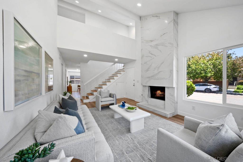 Welcome to 10602 Porto Ct-a beautifully renovated 3-bedroom, 2 bath detached home in the desirable Villa Portofino community of Tierrasanta. This move-in ready home features a thoughtfully designed open floor plan with two guest bedrooms, a full bath, and a laundry room conveniently located on the main level. Upstairs leads you to a private primary suite with vaulted ceilings, dual vanities, a large walk-in closet, and a fully updated en-suite bathroom. The private backyard offers low maintenance turf and hardscaping, plus a covered carport and additional storage. Recent upgrades include: *Brand-new dual paned windows and sliding door *All new interior shaker style doors and electrical panel *New flooring throughout *Stunning floor-to -ceiling tiled fireplace *Recessed lighting and modern light fixtures *Completely updated kitchen with white shaker style cabinets and baths with quartz countertops, new cabinetry, and stainless-steel appliances. *Section 1 Termite clearance completed Enjoy community amenities like a pool, tennis courts, and playground-all with a low HOA of just $190/month. Located within walking distance to Canyon Hills High School, shopping, dining, and just minutes from the 52 and 15 freeways. This home truly has it all-style, convenience, and an unbeatable location. Don't miss your chance to own in one of Tierrasanta's most sought-after communities!