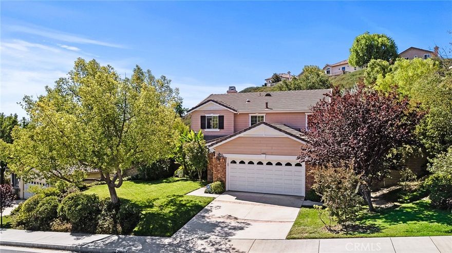 Welcome to this lovingly maintained 4-bedroom, 3-bathroom home in Pacific Hills, one of Santa Clarita's most desirable communities. Featuring nearly 2,400 square feet of comfortable living space, this home blends open-concept design with distinct, well-defined rooms — ideal for both entertaining and everyday living. At the heart of the home is a beautiful, crisp white kitchen showcasing newer cabinets, new sleek and durable quartz countertops, a spacious island, and newer stainless steel appliances including a stove, microwave, and dishwasher. The kitchen opens to a bright and inviting living room, creating a seamless flow while maintaining each space’s individual charm. For convenience, the home includes a full bedroom and bathroom downstairs, perfect for guests or multi-generational living. Upstairs, the primary suite impresses with soaring ceilings, a generous walk-in closet, and a spacious en-suite bathroom designed for relaxation. An additional loft offers flexible space for a home office, playroom, or media area. Step outside to your private backyard oasis, complete with a sparkling pool, new pool pump, and elevated deck — perfect for outdoor dining or soaking in the sunshine. Beautiful landscaping features mature plum and olive trees, adding character and tranquility to the space. Thoughtful upgrades include a whole-house PEX repipe, an updated upstairs guest bath, and other modern touches throughout. Enjoy peace of mind with low HOA dues, no Mello-Roos, and access to an exclusive community park and top-rated schools. This move-in-ready home offers the perfect combination of comfort, style, and location — a true gem that’s not to be missed!