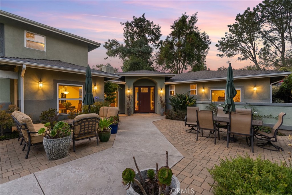 Introducing “Grovehill Hideaway” – Perfectly positioned in the prestigious Banana Hill neighborhood, this 4-bedroom, 3-bathroom, 2,692 sq ft residence combines tranquility and convenience, just minutes from Downtown San Luis Obispo. A wide driveway and gated front patio create a welcoming first impression and offer space to enjoy the coastal breeze or entertain guests. Inside, expansive windows fill the home with natural light, enhancing its bright, airy feel. The sunken living room, framed by corner windows and anchored by a fireplace, offers a cozy setting for gatherings or quiet evenings. The kitchen continues the light-filled theme with white cabinetry, recessed lighting, and a picturesque window overlooking the outdoors. Down the hall, the primary suite is a private retreat with backyard access, a dual vanity, walk-in shower, and soaking tub. Three additional bedrooms provide flexibility for guests, a home office, or creative space. A dedicated laundry room with storage, counter space, and a utility sink adds convenience. The backyard features a pathway around the home, bordered by low-maintenance landscaping for a peaceful, private setting. Whether hosting barbecues, enjoying morning coffee on the patio, or taking in the fresh coastal air, this property offers an effortless lifestyle. Grovehill Hideaway is more than a home—it’s a rare opportunity to own in one of San Luis Obispo’s most desirable neighborhoods, where comfort, charm, and location align.