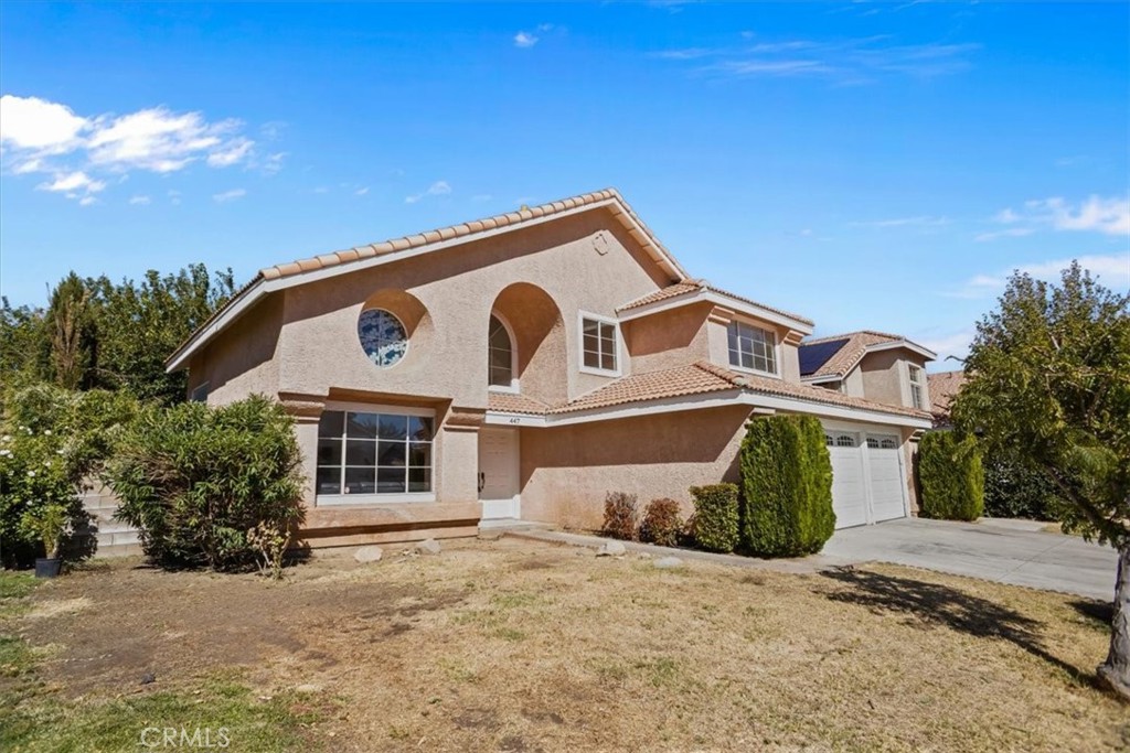 Fantastic opportunity to own this spacious 4-bedroom, 3-bath home featuring a highly functional floor plan and great curb appeal. The entry opens to a large living room with laminate flooring, vaulted ceilings, and plenty of natural light. The generous kitchen offers custom countertops, a gas range/oven, built-in microwave, and ample cabinet space. Just off the kitchen is a comfortable family room complete with a cozy gas fireplace—perfect for entertaining or relaxing. The home includes a convenient downstairs bedroom and a full bathroom, ideal for guests or multi-generational living. Upstairs, you'll find a loft area and three additional bedrooms, including a large primary suite with a jetted soaking tub, separate walk-in shower, dual sinks, and a spacious walk-in closet. The backyard is designed for outdoor enjoyment with a large covered patio, mature trees, decorative curbing, and an above-ground spa (no warranty). Recent upgrades include new carpeting on the stairway and second level. This property also qualifies for a $20,000 grant program for eligible buyers, making it an excellent value. Don't miss this incredible opportunity to own a well-laid-out home with desirable features and plenty of potential.