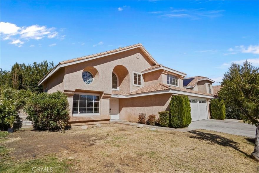Fantastic opportunity to own this spacious 4-bedroom, 3-bath home featuring a highly functional floor plan and great curb appeal. The entry opens to a large living room with laminate flooring, vaulted ceilings, and plenty of natural light. The generous kitchen offers custom countertops, a gas range/oven, built-in microwave, and ample cabinet space. Just off the kitchen is a comfortable family room complete with a cozy gas fireplace—perfect for entertaining or relaxing. The home includes a convenient downstairs bedroom and a full bathroom, ideal for guests or multi-generational living. Upstairs, you'll find a loft area and three additional bedrooms, including a large primary suite with a jetted soaking tub, separate walk-in shower, dual sinks, and a spacious walk-in closet. The backyard is designed for outdoor enjoyment with a large covered patio, mature trees, decorative curbing, and an above-ground spa (no warranty). Recent upgrades include new carpeting on the stairway and second level. This property also qualifies for a $20,000 grant program for eligible buyers, making it an excellent value. Don't miss this incredible opportunity to own a well-laid-out home with desirable features and plenty of potential.