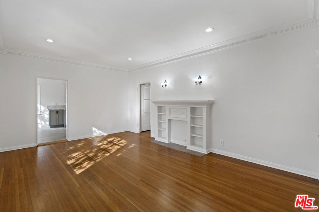 Discover timeless charm and modern comfort in this spacious two-story owners' unit/townhouse, tucked away in a quiet and private four-unit building. This 2-bedroom, 2-bath residence offers original oak floors, elegant period details, and a thoughtful, multi-level floor plan that feels both open and inviting. The bright and expansive living room flows seamlessly into a formal dining area, featuring French doors that open to a large redwood deck with an overhang perfect for al fresco dining or relaxing outdoors. The deck overlooks a lush, green yard with fruit trees (Tangelo and Orange) and thoughtfully arranged vegetable and herb planters, creating your own private garden retreat. The updated kitchen boasts granite countertops, a chef's pantry, and comes equipped with a refrigerator, stove, microwave, and dishwasher. A cozy breakfast nook nearby doubles as a charming office space. Adjacent to the kitchen, you'll find a laundry room and ample storage, including a large under-stair storage area. Upstairs, both bedrooms offer comfort and privacy, bathed in natural light. Additional highlights include one off-street parking space, with permit parking available, and a serene location just one block from Rancho Park. Enjoy close proximity to Westfield Century City, Beverly Hills, and the 405 freeway, with the beach just a short drive away.