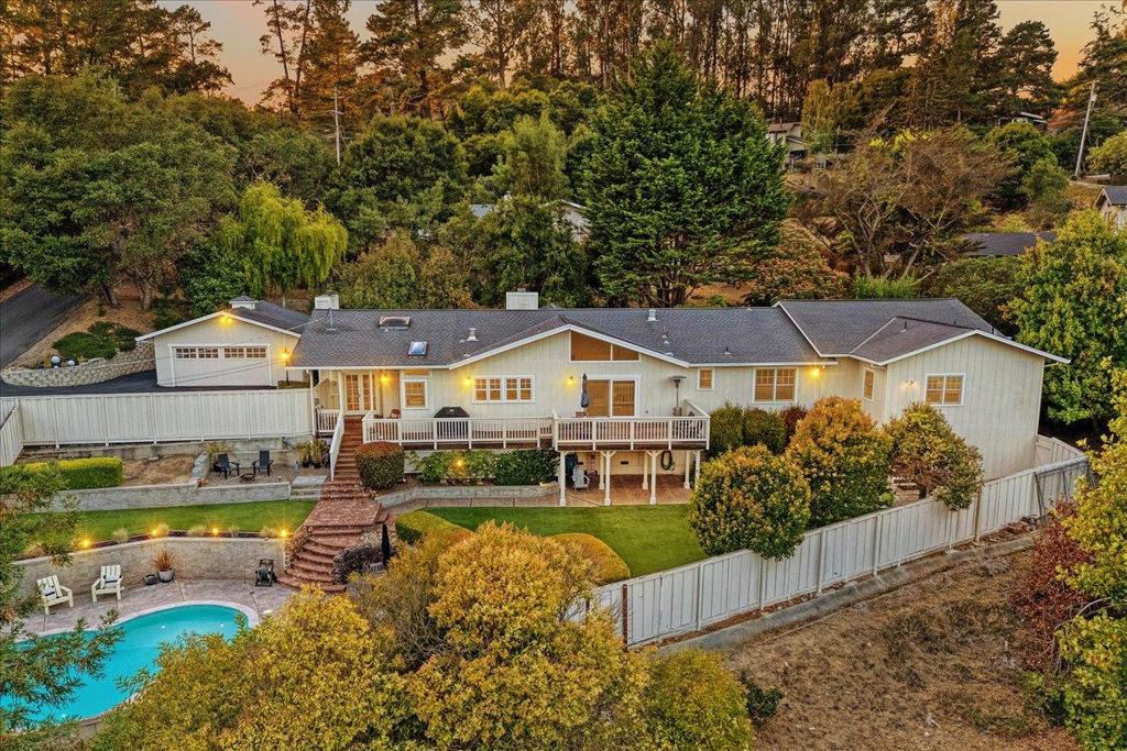 Welcome to 455 Calle Del Sol, a peaceful retreat nestled in the heart of Aptos' coveted Day Valley. From the moment you arrive, this home feels like a sanctuary, where every detail invites you to slow down, connect, and savor the beauty around you. Step inside and be greeted by soaring vaulted ceilings that fill the living spaces with light and openness. The kitchen and dining room offer sweeping views, the kind that make even an ordinary meal feel extraordinary. With both a grand primary suite and an additional mini suite, comfort and privacy are built in for family and guests alike. This home was designed for living well, whether that means hosting lively gatherings with friends, enjoying cozy nights by the fire, or seamlessly moving the celebration outdoors. Picture summer days spent lounging by the sparkling pool, evenings under the stars, and a quiet escape to the bonus recreation room for a little me time. Tucked away for privacy yet just minutes to town, 455 Calle Del Sol offers the best of both worlds: tranquility and convenience. It's more than just a house, it's where laughter carries across the pool, where traditions are made, and where you'll always look forward to coming home.
