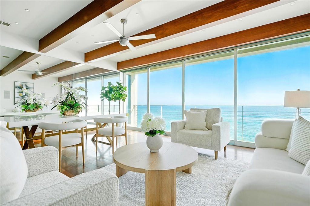A sophisticated modern beachfront residence featuring upscale design and coastal living vibes. Nestled along a quiet stretch of coastline, this impeccably renovated two-bedroom, two-and-a-half bath beachfront property delivers unmatched coastal elegance and stands as a serene escape from the bustle of everyday life. Upper-level living area feels like floating over the ocean thanks to the expensive windows and panoramic views. Floor-to-ceiling windows frame sweeping views of the ocean, letting in golden sunlight that dances across the polished hardwood floors. With an open-concept layout, the spacious living room and kitchen flow seamlessly together, all set against a backdrop of jaw-dropping ocean views that stretch endlessly from nearly every room. Sleek, fully equipped cook’s dream kitchen is beautifully designed and functional. Lower level hosts the master suite and a secondary suite with its own kitchen, easy sand access. Additional features include two-car tandem covered parking, a private laundry closet, and direct access to all the amenities of the Malibu Bay Club, including a sparkling pool, relaxing spa, and two sports courts, for an active coastal lifestyle. Perfectly located just minutes from Pepperdine University, County Line Beach, and Leo Carrillo State Park. Whether for intimate living or seaside entertaining, this Malibu gem offers a uniquely immersive coastal lifestyle. It’s a place where time slows, and the ocean is your constant, calming companion.