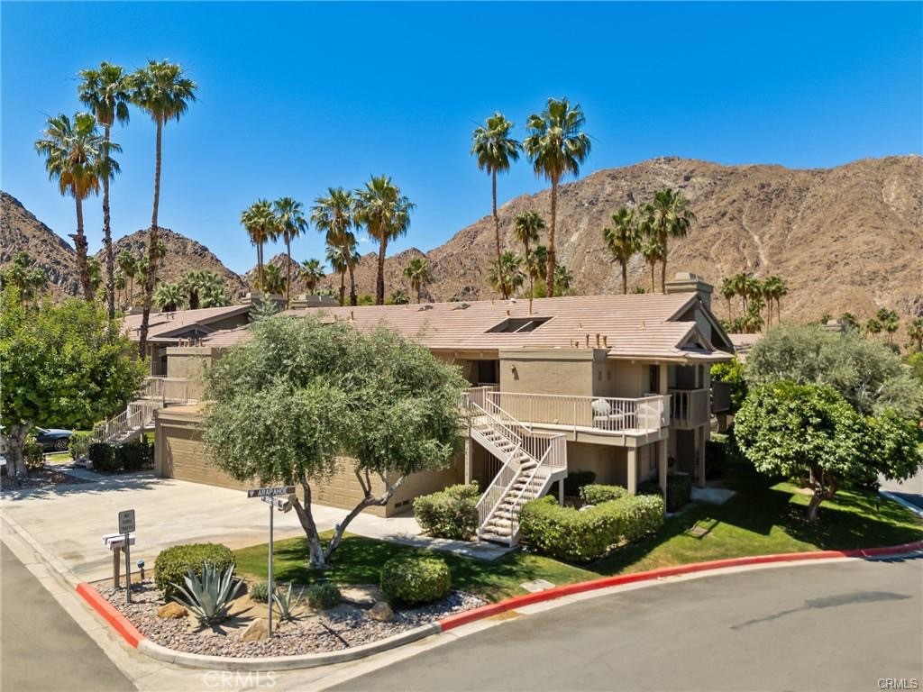 Elegant Living in Indian Wells. Discover the serene beauty of Indian Wells in this exquisite 2-bedroom, 2-bathroom condo, nestled within the private, gated community of Mountain Cove. Spanning 1,446 sq ft, this lower-level unit offers a seamless blend of comfort and luxury, perfect for the discerning buyer. Inside you will find a meticulously designed living space featuring central air conditioning and a cozy fireplace in the living room, ideal for relaxing evenings. The home boasts high-end stainless steel appliances and a convenient laundry room off the kitchen, ensuring both style and functionality. The private, extended wrap-around patio offers a tranquil retreat, overlooking a lush green belt and offering breathtaking views of the mountains—an idyllic backdrop for morning coffees or sunset dinners. Residents of Mountain Cove enjoy exclusive access to three nearby community pools and are just moments away from the Indian Wells Golf Resort. This condo includes a heated swimming pool just steps away from the unit. The location is unmatched, with proximity to the vibrant festivals of Coachella and Stagecoach, placing world-class entertainment at your doorstep. The covered 1-car garage is shared with the neighbor and adds a layer of convenience and security, directly attached to the unit. Living in Indian Wells offers a unique lifestyle characterized by spectacular natural beauty, cultural richness, and a close-knit community atmosphere. Experience the best of Coachella Valley living, where every day feels like a vacation.