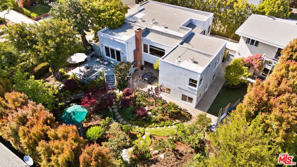 Luxuriate in your own private countryside in the heart of Century City. This extraordinary family home -- on the market for the first time in almost 40 years -- sits on a gorgeous, expansive lot -- 10,952 sq foot (over .25 acre), one of the largest in the neighborhood. The inviting main house is thoughtfully appointed with hardwood floors, crown moldings awash in natural light pouring into the spacious living and dining rooms. At its center is the gourmet kitchen, featuring stainless-steel appliances including a 6-burner Bertazzoni range, with a show-stopping view of the sweeping verdant landscape; four bedrooms and two baths complete the main level. On the lower floor is a full, rentable apartment enveloped in garden views; over the garage, an airy studio space provides flexibility as a home office, gym or guest suite. Both units are permitted, may be configured to create a family compound. Hidden behind mature hedges, the thoughtfully planted and meticulously tended lush garden is a serene spot to enjoy bucolic surroundings while maintaining prime access to world-class shopping, restaurants and entertainment within minutes. The scale of the grounds will inspire the new steward of this unique property, presenting options to reimagine the spaces a/o move right in and generate additional income.