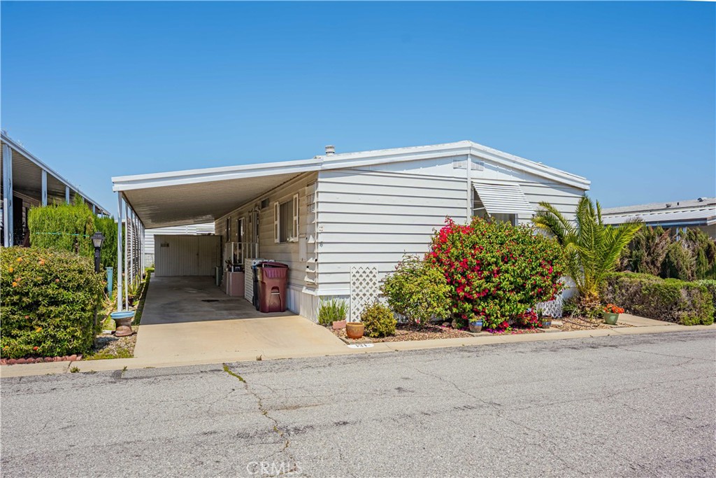 Welcome Home to Hillside Mobile Home Estates, Gated 55+ Park Community in Menifee. Your Search is over! This Lovely Home offers: 2 Bedrooms & 2 Baths with plenty of room at 1,440 Sqft (A) of Living Space. Brand NEW Waterheater, Just Installed! Open Kitchen into Living Room with lots of Cabinets, Double Oven, NEW Garbage Disposal, Pull Out Shelving & more. Entertain with a Built-in Bar in the Living Room & also a Built-in China Cabinet in Dining room. The Primary Main Bedroom is Spacious with its own Private Bath with Garden Soaking Tub, stand alone Shower, Tile Floors & Mirrored Sliding Closet Doors. Guest: 2nd Bedroom, located near Primary, Mirrored Closet Doors & a Jack N Jill Bathroom leading into the Laundry Room. Lovely Front Porch w NEW Ramp & Attached Carport that can fit 2 Cars with a Large Shed. Additional Parking close by so guests do not need to walk far. Community Offers: Large Clubhouse, Swimming Pool, Spa, Weekly Activities & offers an on-site RV Storage. Close to Shopping Center, Banks & Restaurants! Come see your NEW Home TODAY!