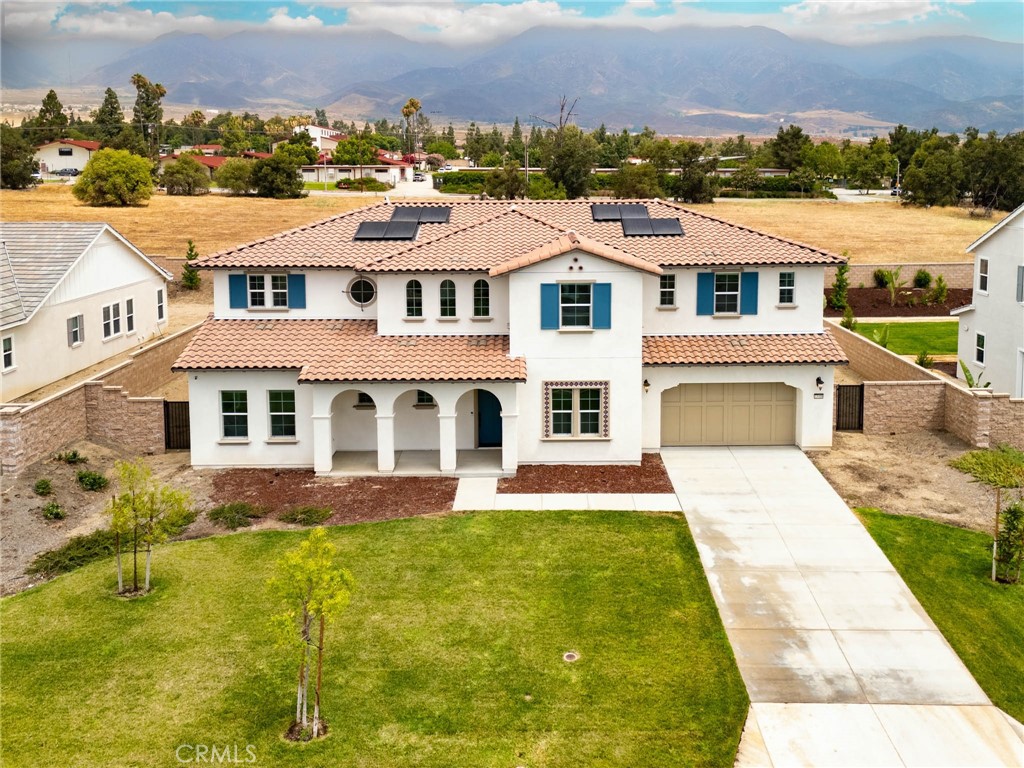 Welcome to this flawless south-facing, mountain-view estate in Rancho Cucamonga. Nestled in a peaceful and upscale neighborhood north of the 210 freeway, this nearly new 2023-built home offers the perfect blend of luxury, space, and functionality. With 6 bedrooms plus home office, 4.5 bathrooms, and approximately 4,766 sq ft of refined living space on a generous 15,557 sq ft flat lot, this property has it all.
Step into the grand foyer with soaring 19-foot ceilings and rich wood-look luxury vinyl flooring. The dedicated office, enclosed by stylish barn doors, offers a quiet and elegant space for remote work. The main level also features one private ensuite and an additional bedroom currently used as a gym, complete with sliding glass doors opening to the backyard—ideal for indoor-outdoor workouts or seamless pool access.
The sellers spared no expense, investing over $200,000 in builder upgrades to make this home truly better than the model. Highlights include crown molding throughout, gourmet kitchen with Italian-made cooktop, upgraded cabinetry, marble countertops, built-in refrigerator, double oven, and two built-in wine coolers. Other upgrades include double barn doors at the office, upgraded stair railings, indoor and outdoor surround sound systems, custom built-in shelving and cabinetry with stone countertops, designer tile finishes in the upstairs bathrooms and laundry room, dual bedside light switches in the primary suite, pre-wired TV outlets in multiple rooms, epoxy flooring in the three-car garage, paid-off solar panels with SunPower reserve battery, and EV charging outlet. The list goes on and on.
Beyond these builder upgrades, the home also features thoughtful custom enhancements such as whole-house water softener and purification system, custom-designed window coverings throughout, professionally designed built-in closets, Bluetooth-controlled smart irrigation system, and pre-installed holiday lighting, all app-controlled for ultimate convenience.
The oversized backyard is a blank canvas—ready for your dream outdoor oasis, future pool, or even an ADU. Located within the highly rated Etiwanda School District and close to top-tier schools, major shopping centers, and convenient freeway access, this luxury home is perfectly situated in the crown jewel of the Inland Empire. Don’t miss the opportunity to own this extraordinary estate—come see it and fall in love.