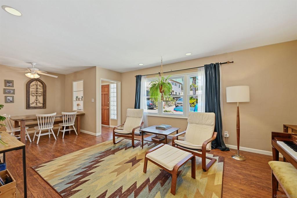 Welcome home to your private oasis in the Bay Park neighborhood of Clairemont, just one mile from Mission Bay! This beautifully updated home offers a bright, open-concept floor plan with vaulted ceilings, skylights, elegant recessed lighting, and ceiling fans throughout. Enjoy both formal and informal living and dining areas, perfect for relaxing or entertaining. The spacious kitchen features sleek new stainless steel appliances. The primary suite includes a full en suite bathroom, while two additional guest bedrooms provide comfort and convenience. This home boasts OWNED solar and a new roof. Located on a canyon, the professionally landscaped backyard retreat features mature avocado, orange, and fig trees, plus a producing peach tree. Enjoy a custom putting green, decomposed granite pathways, and a charming gazebo equipped with a fan, sun shades, and electricity. Get your workout in your detached shed/gym space. The one-car garage includes an EV “pocket garage” charging setup. An attached, finished 350 sq ft ADU with a private entrance, kitchenette, and full bath is perfect for guests, extended family, or rental income. Enjoy canyon and peek-a-boo ocean views—all just minutes from the I-5 freeway.