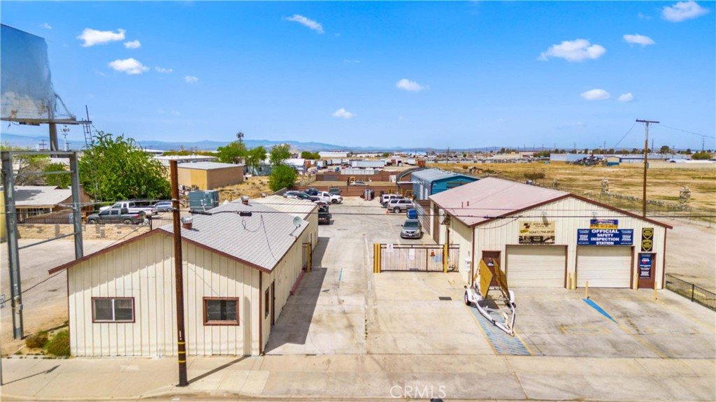 Industrial zoned property with improvements located on a main street with other established businesses. High traffic area in close proximity to freeway (CA-14). Property is currently occupied by owner and two tenants with one vacant building available for immediate occupancy by new owner. Existing tenants pay $3700 per month plus shared cost of utilities. Owners expenses include property taxes and insurance.
Front portion of property (street side) includes three structures with a combined square footage of 6685. Each building includes it’s own bathroom. Building on the left (when facing the property from the street) is vacant and offers 2270 sqft of office and warehouse space. The rear portion of the property is vacant / leveled dirt and may be developed to provide additional rental space. Cement block wall on three sides with a gate facing the mainstreet. Parking spaces available.
This property includes two parcels under a single legal description - see the plotted easement in the photos. The total lot size for this property is 1.1 acres.