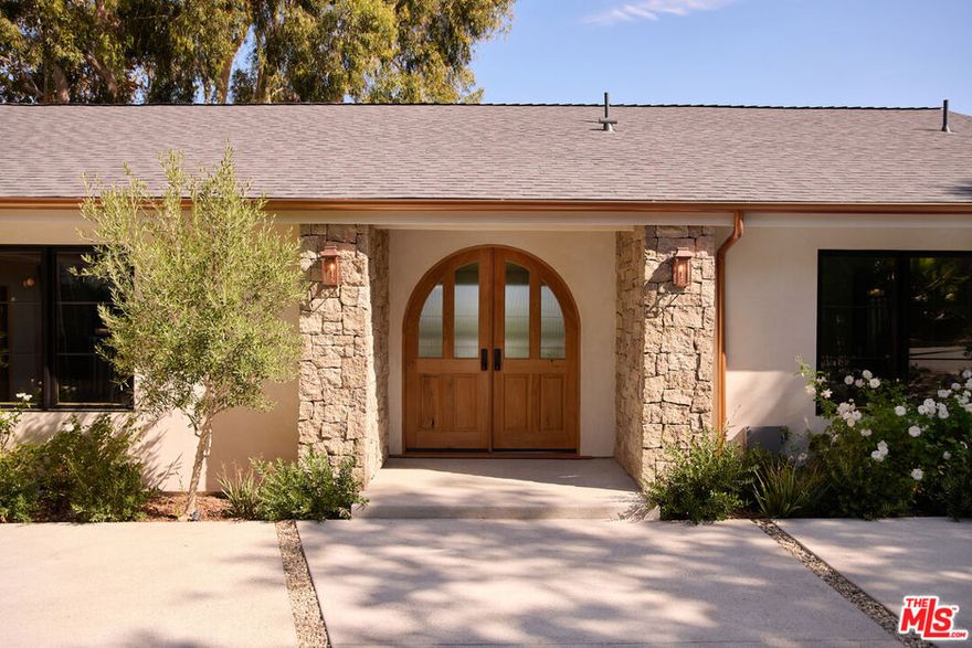 Tucked away yet just minutes from Studio City's best dining, shops, and entertainment, 3620 Wrightwood Drive offers a rare blend of privacy and convenience. The home feels effortlessly open, with glass doors connecting the living room and kitchen to a backyard made for lingering. A bubbling spa, covered patio, and a deck that stretches toward the horizon create a serene retreat where inside and outside become one. A subtle gas fireplace warms the space without interrupting the open flow. The home offers five bedrooms and four and a half baths, balancing versatility with intimacy. The primary suite is a private sanctuary, featuring a walk-in closet, a grand shower, and floor-to-ceiling glass doors that open directly to the backyard, merging interior and exterior into a seamless space of light, sky, and fresh air. The kitchen is a chef's dream, outfitted with Jenn Air appliances and sleek custom cabinetry, flowing effortlessly to the deck for casual breakfasts, sunset dinners, or effortless entertaining. Every corner encourages pause and presence a morning coffee overlooking greenery, an evening in the spa under the stars, or a gathering that moves naturally from indoors to outdoors. Here, the world feels vast yet intimate. The energy of Laurel Canyon and Hollywood is just minutes away, but inside, you can stop, breathe, and savor a sense of peace that's increasingly rare. 3620 Wrightwood Drive isn't just a home - it's a private escape that invites you to live fully, both in comfort and in connection with the city around you.