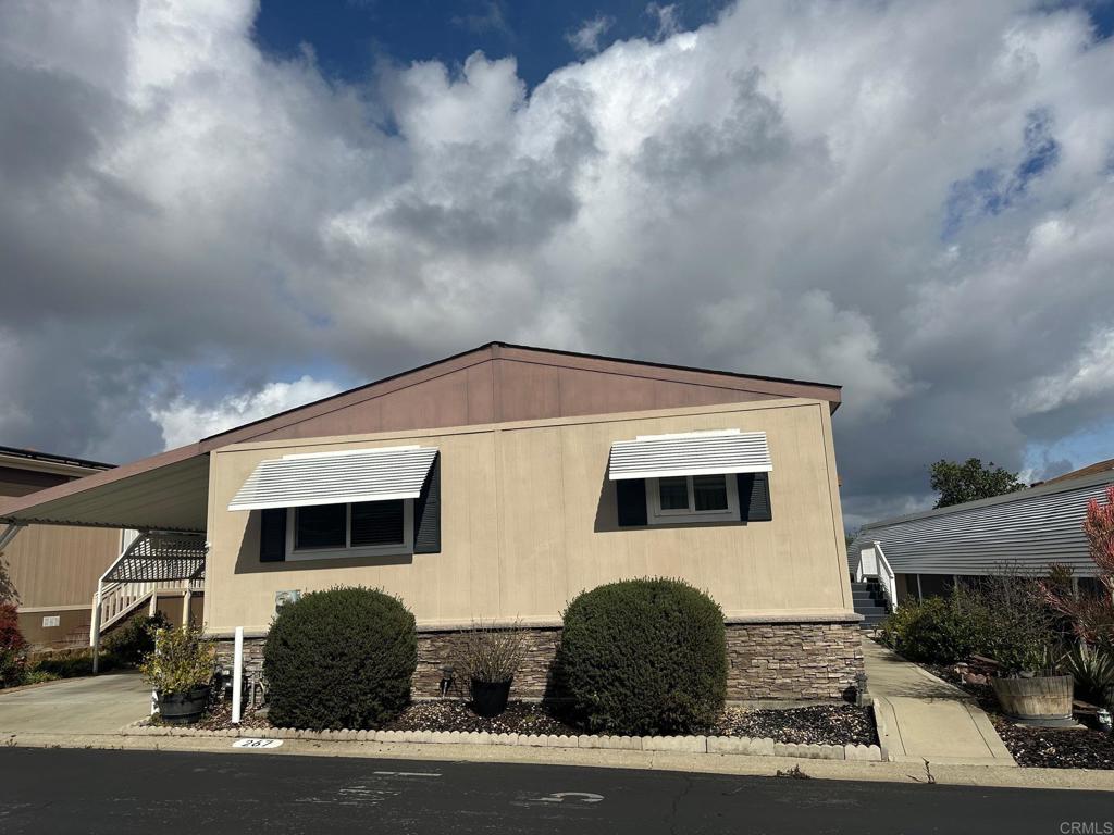 Welcome to your dream retirement home! Situated in 5-star, 55+ community of Rancho Escondido, where you own the land! This beautiful home has so much to boast about!! As you enter, you are welcomed into a great room that incl. a large living room, kitchen w/large island seating & dining area. From every window in this great room, inc. a sliding glass door to a huge rear Trex deck, there are incredible views to soak in. The home itself shows real pride of ownership, Hardiboard siding, as well as, built to match shed. Vaulted ceiling down center of the home, neutral paint colors, crisp white 3-panel doors, inc. closets. All bedrooms w/carpet, the rest of the home has upgraded neutral laminate plank floors. Wonderful kitchen...large pantry & island have pull-out shelves. Recessed lighting & pendant lighting over island. Granite counters thruout. Large primary suite  & bath w/separate room for toilet, built in linen & full shower.  3-car carport.