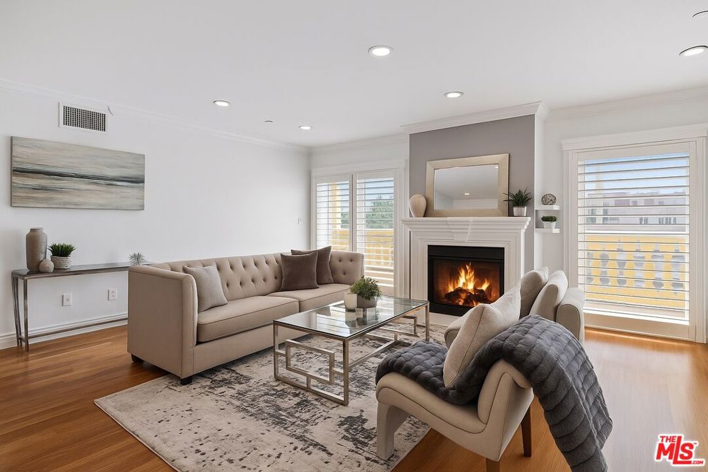 Step into refined sophistication with this stunning penthouse, perfectly situated in one of Los Angeles' most coveted neighborhoods. Boasting sweeping city and hillside views from a private rooftop deck, this home offers an extraordinary blend of luxury, comfort, and California elegance. Flooded with natural light, the expansive interior features 3 spacious bedrooms, 2 inviting fireplaces, and an open-concept layout that effortlessly blends modern style with timeless charm. Thoughtfully designed for both relaxation and entertaining, the generous living areas flow seamlessly onto multiple outdoor spaces, ideal for hosting guests or enjoying tranquil evenings under the stars. The stylish kitchen and oversized rooms offer ample storage and closet space, while high ceilings and large windows create a bright, airy ambiance throughout. Whether you're unwinding by the fire or taking in the sunset from your rooftop retreat, every corner of this home is designed to impress. All this, just blocks from the world-class shopping and dining of the Beverly Center, famed restaurants like "The Ivy", and minutes from the pulse of the Sunset Strip!