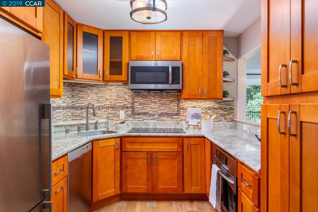 Fantastic downtown location! Nothing left to do, just move in and enjoy this new on market condominium with gorgeous and tastefully appointed updates throughout! Fabulous kitchen with stainless steel appliances, pantry, decorative glass tile backsplash, under cabinet lighting and slab granite counters with extended breakfast countertop opens to spacious living/dining areas. Large master bedroom with private updated bath and wood frame glass door to balcony. Extensively upgraded with engineered wood flooring, crown moldings, custom millwork, fresh interior paint, designer lights and window coverings, ceiling fans, sliding barn doors, mirrored closet doors and dual pane windows throughout! Enjoy end of day tranquil wooded and creek views from your private balcony. 10 Acre City park, bike/walking trails, BART, destination dining and desirable schools all nearby!