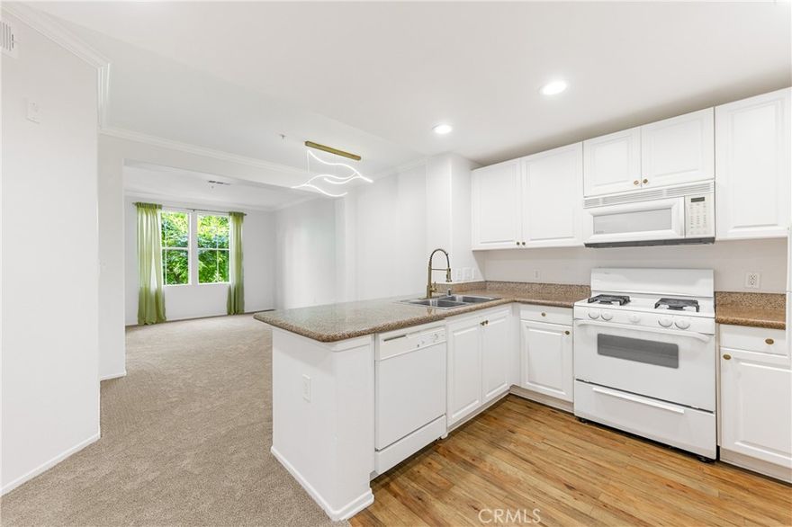 Beautiful Dorchester model located on the 2rd floor with a courtyard and fountain view! Beautiful morning light and the privacy of the trees! This one bedroom one bathroom home features cozy den that could be used as an office, granite counter tops, in-unit stackable washer and dryer, his and her sinks in the master bath. Enjoy soothing breeze from the a large private balcony! The sophisticated living of the Watermarke community offers bounty of amenities including concierge services, business and fitness centers, movie theater and billiards rooms, 3 pools, 4 spas, and an indoor basketball and tennis courts. Gated parking structure with 2 assigned parking spots. Refrigerator and stackable washer and dryer are included in the sale. Come see this cozy condo and make Watermarke your home!