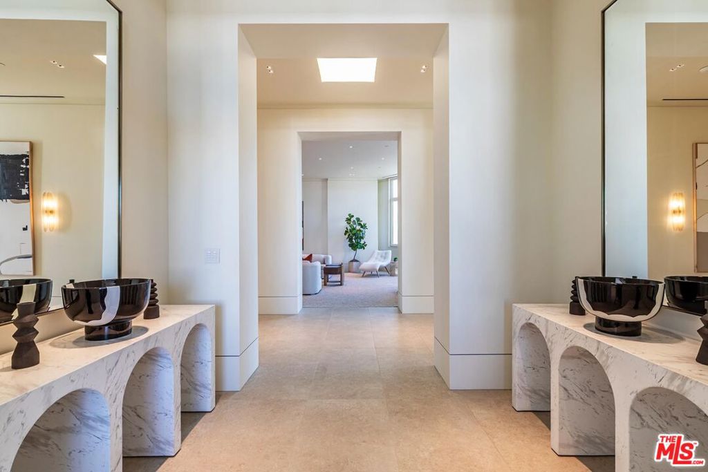 Introducing SKY 455, the pinnacle of penthouse living in Beverly Hills. This rare, full-floor residence offers unmatched privacy, luxury, and exclusivity. Perched atop a five-residence building, this architectural masterpiece by Fields & Deveraux represents a unique opportunity in Los Angeles' highly competitive luxury condo market. A private elevator opens to the sun-drenched architecture of Richard Hallberg, where soaring 10-to-12-foot ceilings and gallery-like spaces provide an exquisite setting for art collectors and grand-scale entertainers alike. The open living and dining areas flow seamlessly, blending sophistication with comfort for both intimate and large gatherings. A true highlight of the home is the expansive 975-square-foot private rooftop deck, boasting panoramic views of the Hollywood Hills and San Gabriel Mountains. With the potential to reinstate a private plunge pool, this outdoor retreat transforms the penthouse into a true sanctuary in the sky. Featuring 3 bedrooms and 6 bathrooms, this home is outfitted with the finest materials and finishes, including Miele and Sub-Zero appliances, white oak cabinetry, handmade glass sconces, custom walk-in closets, a Lutron lighting system, and motorized shades. Four side-by-side parking spaces complete this exceptional offering. With no other move-in-ready condominiums of this size and caliber currently available in Beverly Hills, SKY 455 delivers a rare blend of scale, style, and exclusivity in the heart of Beverly Hills.