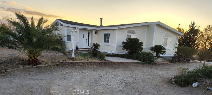 Beautifully remodeled and move-in ready! This 3 bedroom, 2 bath homes offers 1,196 sq ft of living space on 2.37 acres in a peaceful, quiet setting and is filled with plenty of natural light. Recent upgrades include new vinyl plank flooring throughout, fresh interior paint. Home has a newer roof and central AC and heating. 

The kitchen shines with white shaker cabinets, quartz-style counters, stainless steel appliances, and an island with seating that opens to the dining and living areas. Bathrooms have been fully updated with sleek vanities, marble-look counters, matte black fixtures, and stylish lighting.

The open floor plan includes a welcoming living room with wood-burning fireplace and a spacious primary suite with a separate tub and shower. Mud room can be used as an extra room or game room. Outside, the fully fenced property provides ample space for gardening, entertaining, or simply enjoying the peaceful desert landscape.

With its modern upgrades, natural light, and serene location, this home offers comfort, style and lots of room to grow.