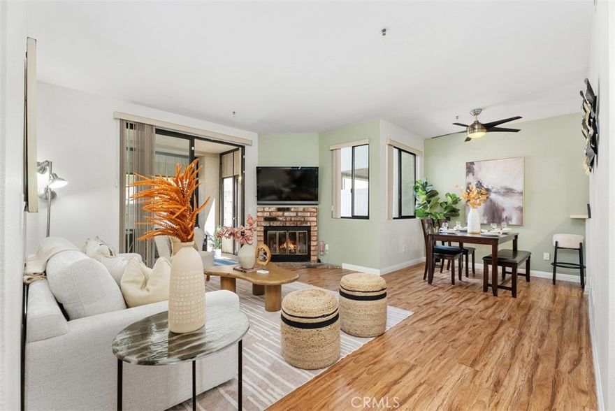Welcome to this beautifully updated 2 Bedroom 2 Bathroom single level condo. Featuring 2 Master Suites, each with its own full bathroom and walk-in closet.  One bathroom includes a tub with shower, while the other has a walk-in shower for added versatility. Enjoy the open living space with high ceilings, a fireplace in the living room, and laminate wood-like flooring that brings warmth throughout. The upgraded kitchen offers plenty of storage, modern finishes, and is paired with the convenience of an in-unit stackable washer and dryer located in the kitchen closet. Parking is convenient with a 1-car detached garage, an additional assigned space, plus ample guest parking. This home is move-in ready and offers the perfect blend of style and function in a desirable location, near the beach, trendy restaurants, and local grocery stores, you’ll have everything you need just minutes away.