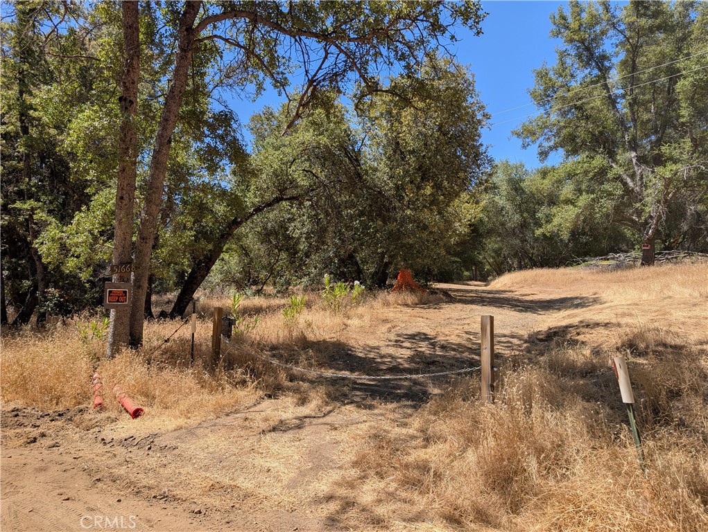 Terrific opportunity to purchase this lovely, level 7.3 acre parcel in Oakhurst, California with well, electricity, building pad, views, plus an existing barn.
Very usable land, with a creek running across a portion. A building pad with privacy and distant mountain views has been leveled and brushed, the well was 8 GPM in 1999. The barn is a spacious 30' x 100' on a concrete pad with water and electric; a smaller shed was shmooshed by a tree in the storms, and is on a concrete pad and has water and power. There's water and power at the entrance to the lot. Bring your ideas & dreams and make it your own!