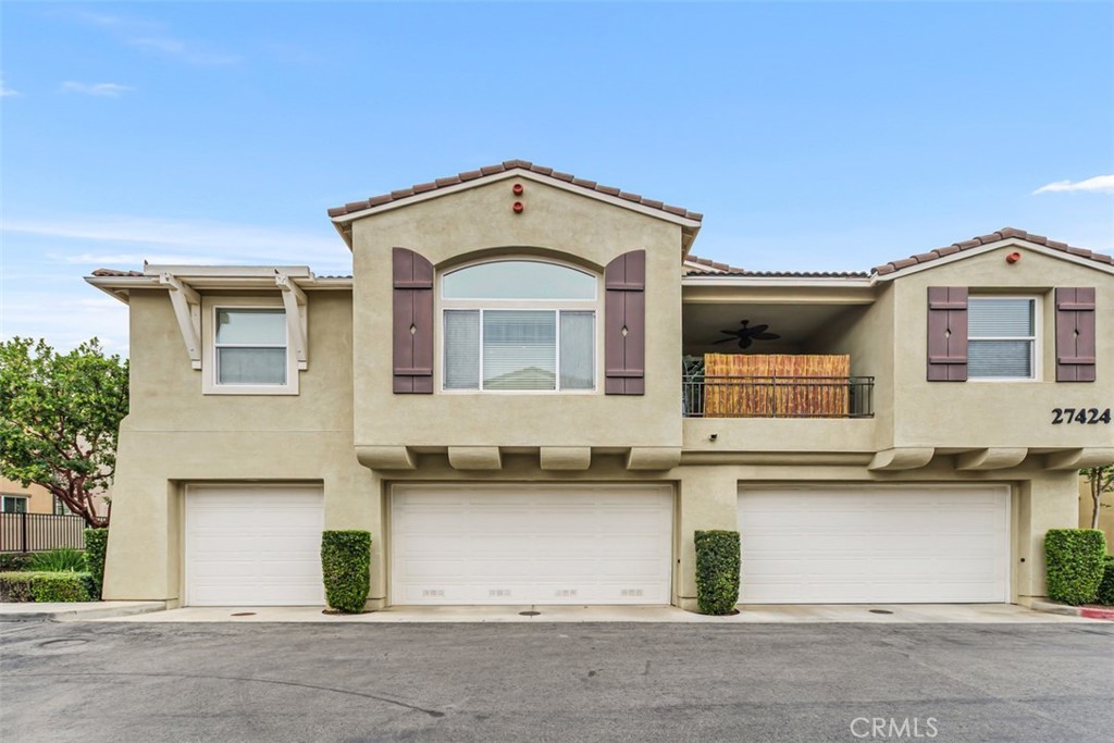 Great curb appeal. Three unit building with subject unit entry on the left. This home extends the entire width of this building over the garages.