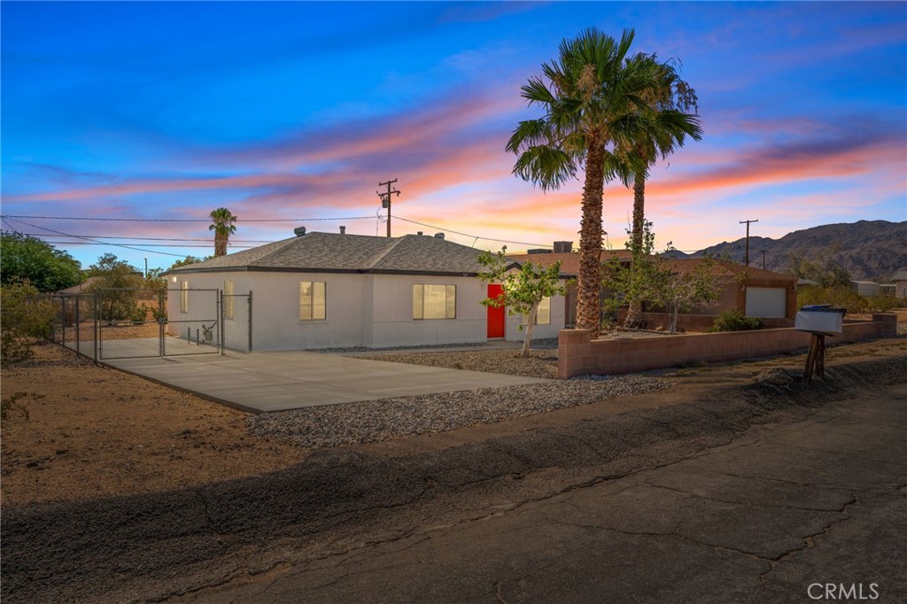 Desert Charm Meets Modern Comfort – Fully Remodeled 3-Bedroom Home Near Joshua Tree National Park. Step into serenity with this beautifully renovated 3-bedroom, 2-bath home, nestled in the peaceful community of Twentynine Palms—just minutes from the majestic entrance to Joshua Tree National Park. Whether you're seeking a primary residence, a weekend escape, or a vacation rental investment, this home invites you to experience the desert lifestyle in comfort and style. Inside, you’re greeted by the clean scent of fresh paint and the cool feel of brand-new tile flooring underfoot. The open layout is flooded with natural light, complemented by warm modern lighting fixtures and ceiling fans in every room, creating a breezy, inviting atmosphere. The master suite feels like a private retreat, featuring a spa-inspired bathroom with sleek double sinks and a walk-in shower—the perfect way to unwind after a sun-drenched day outdoors. Breathe in the fresh desert air from your large covered patio, where golden hour sunsets paint the sky in pinks and purples, and the silence is broken only by the occasional breeze or call of a desert quail. This is a space where morning coffee becomes ritual, and evenings stretch out under a canopy of stars. A new high-efficiency central heating and air system ensures year-round comfort, while upgraded plumbing and lighting fixtures offer modern function with stylish form. Every inch of this home has been thoughtfully designed to be both beautiful and practical—truly move-in ready. Beyond your doorstep, explore the rich culture and natural beauty of the area. From hiking iconic trails in Joshua Tree, to visiting local art galleries, enjoying open-air markets, and stargazing at Sky's The Limit Observatory, Twentynine Palms is a vibrant desert community with both soul and convenience. Essential amenities like schools, grocery stores, and dining spots are just minutes away. Come feel the stillness, the beauty, and the potential. This is more than a home—it’s a lifestyle.