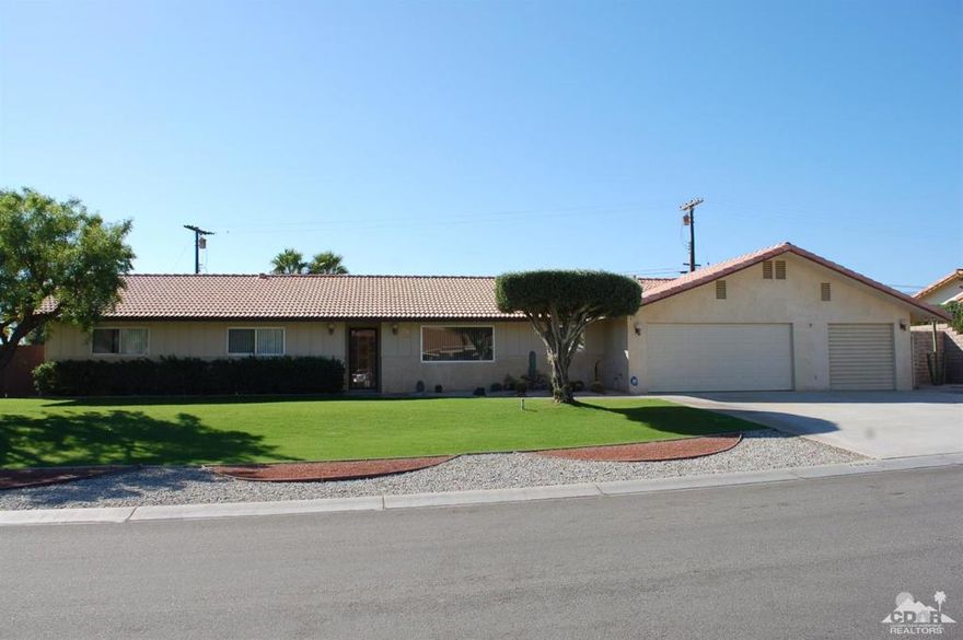 Wow! Don't miss seeing this well built, upgraded, ranch style home in the desirable Westward Ho enclave. This unique neighborhood is located in the ungated portion of the Indian Springs Golf Course/Country Club in the City of La Quinta. It has had only one owner, the original builder of this home and has been upgraded with a concrete tile roof and energy efficient dual pane glass throughout. The ranch style floor plan includes a sunken living room with vaulted/beamed ceilings, sliding glass doors to the covered rear patio and huge rear yard, an elevated dining area with custom built-in China cabinets, hutch and buffet, a family room just off the kitchen and 3 good sized bedrooms plus two bathrooms. The master suite includes his and hers wardrobe closets and a private bathroom. There is a bonus room off the two car garage that was used as an office and there is large workshop off of the third car garage. Other features include huge indoor laundry, cabinets, storage and so much more!