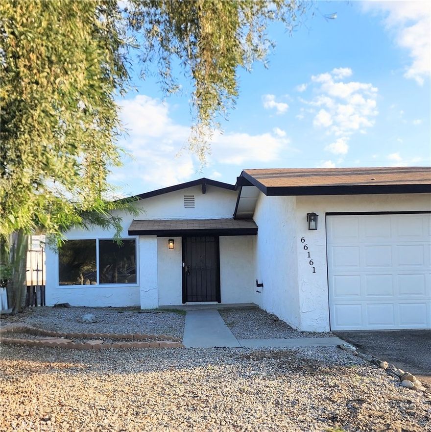 Lovely 4 bedroom 2 bath home in the Cornerstone community of north Desert Hot Springs. Recently updated with modern white shaker cabinets, vinyl flooring, led lights, new paint inside and outside, New energy efficient windows. As you enter the home you will find a large living room with loads of natural light great for entertaining. The dining area is to your right and leads into the kitchen. The slider in the kitchen opens into the side yard perfect for enjoying dining al fresco. From the living room, the hallway guides you to three guest bedrooms and the main bedroom. All four bedrooms have plenty of closet space, ample room for all your treasures. The home has two bathrooms, the guest bathroom down the hallway on the right and a private ensuite bathroom off the primary bedroom. The home has a newer central air conditioner and forced air heating. Up the concrete drive there is a 2 car garage with abundant room for storage and the side yard has RV access potential. The home has a fully fenced yard accessed through the garage or the gates on either side of the home with an added fenced area in the back, perfect for keeping pets separate from the side yard. The property is clean and graded ready for your personal landscaping touch. The property is less than two miles from the shops & services in downtown Desert Hot Springs and just 13 miles to the vibrant world of Palm Springs. Come call this property home.